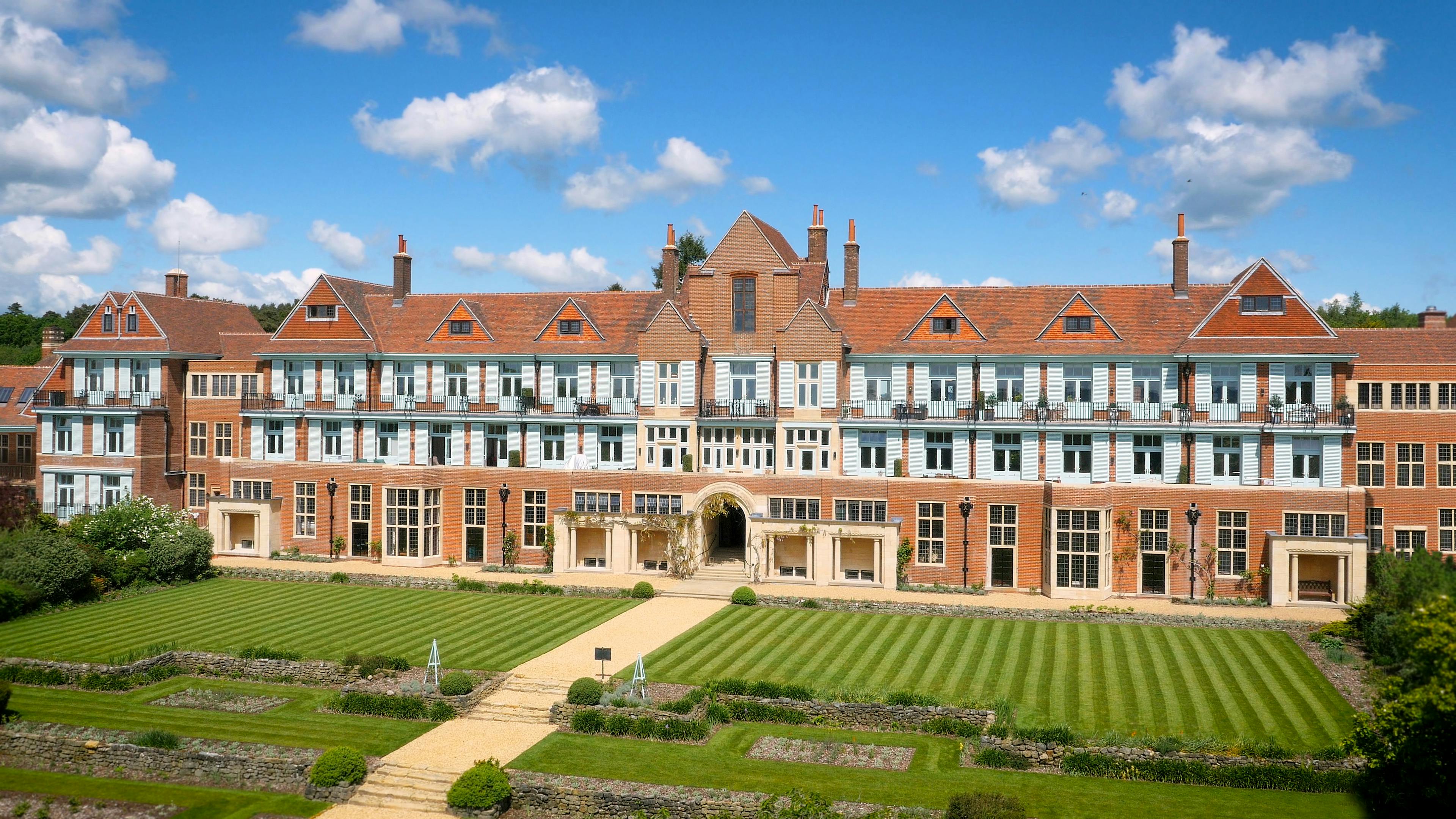 Caption: a large building with a lawn in front of it