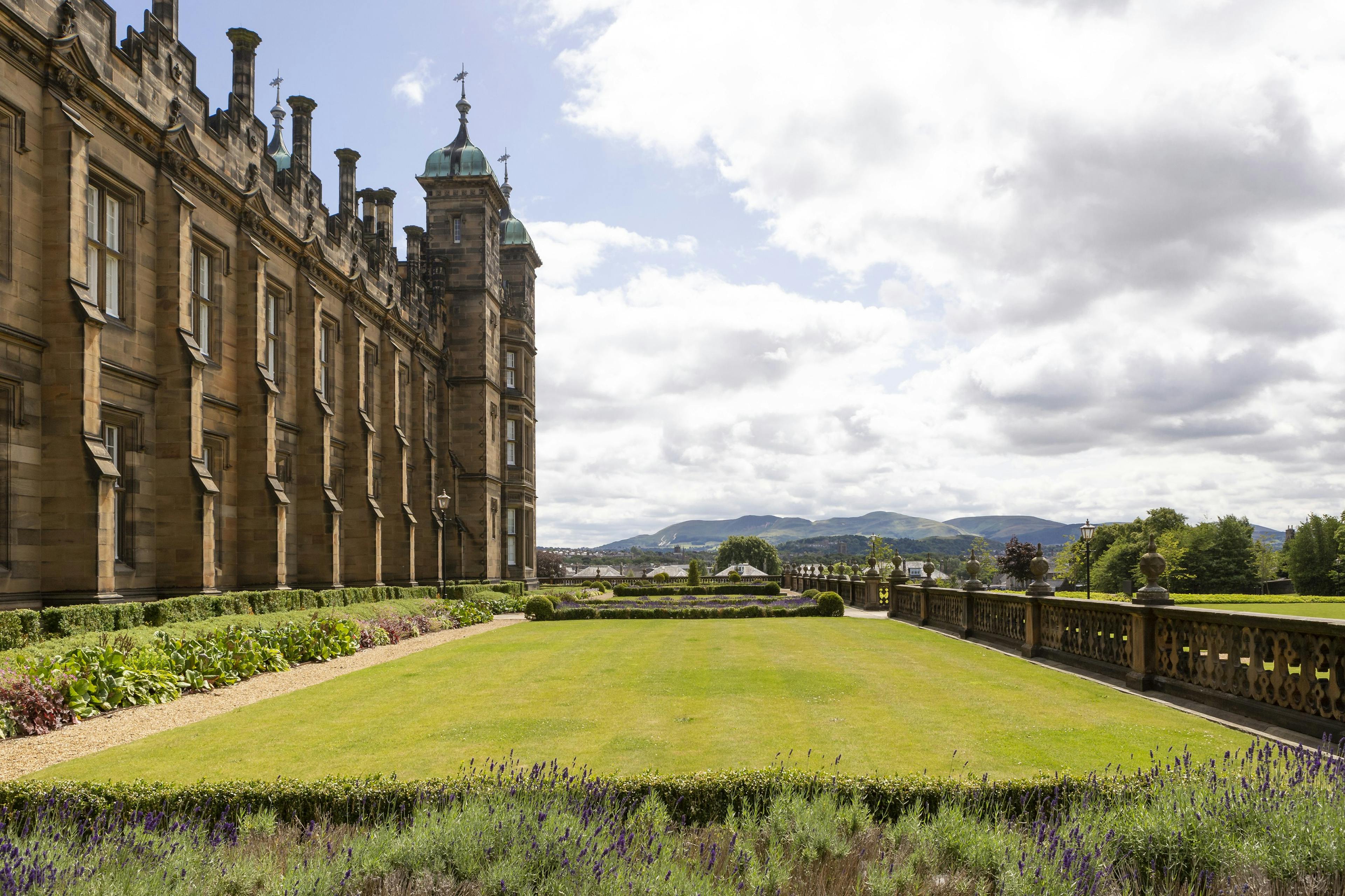 A grand building with manicured gardens