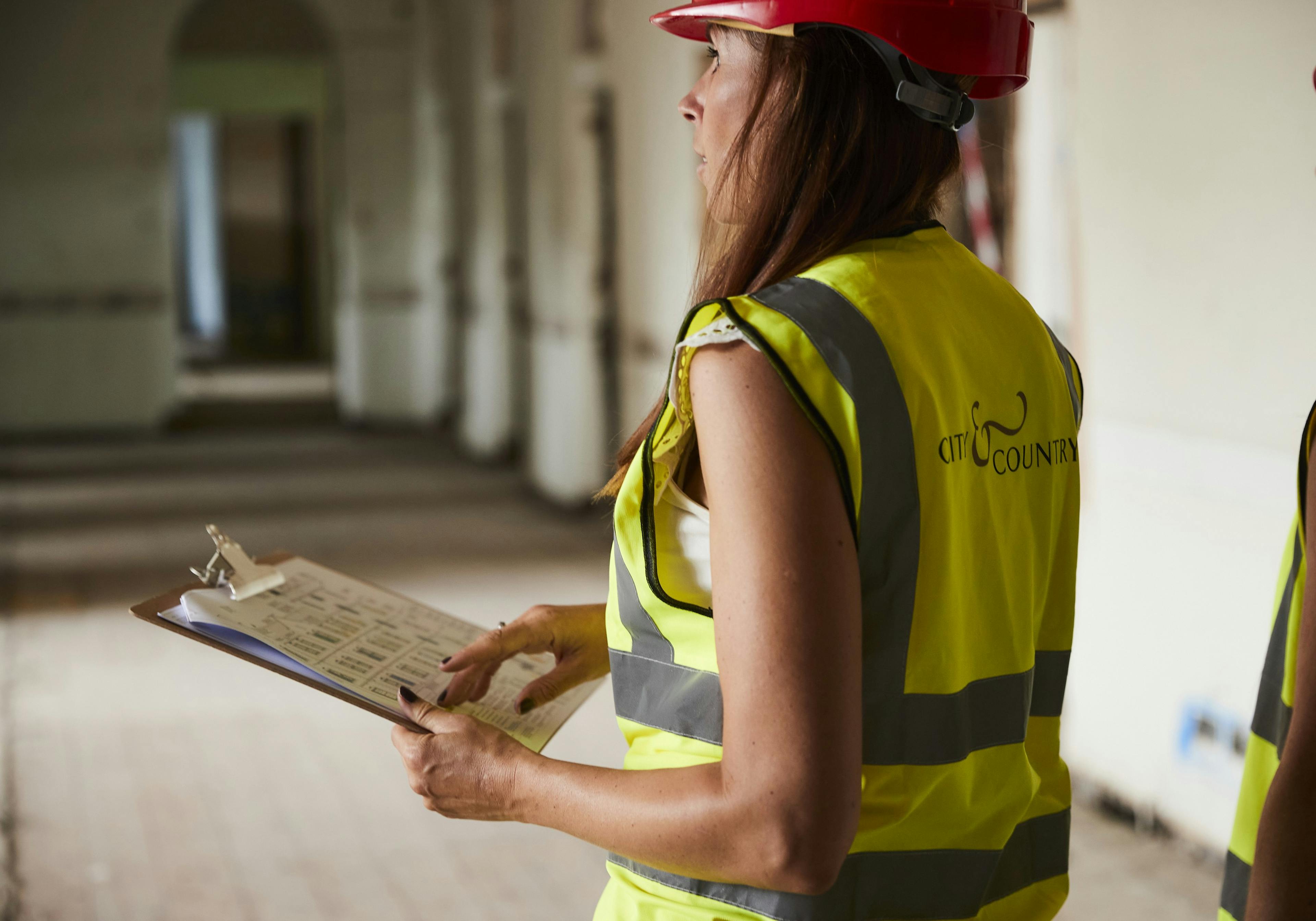 A lady wearing PPE doing a site walk