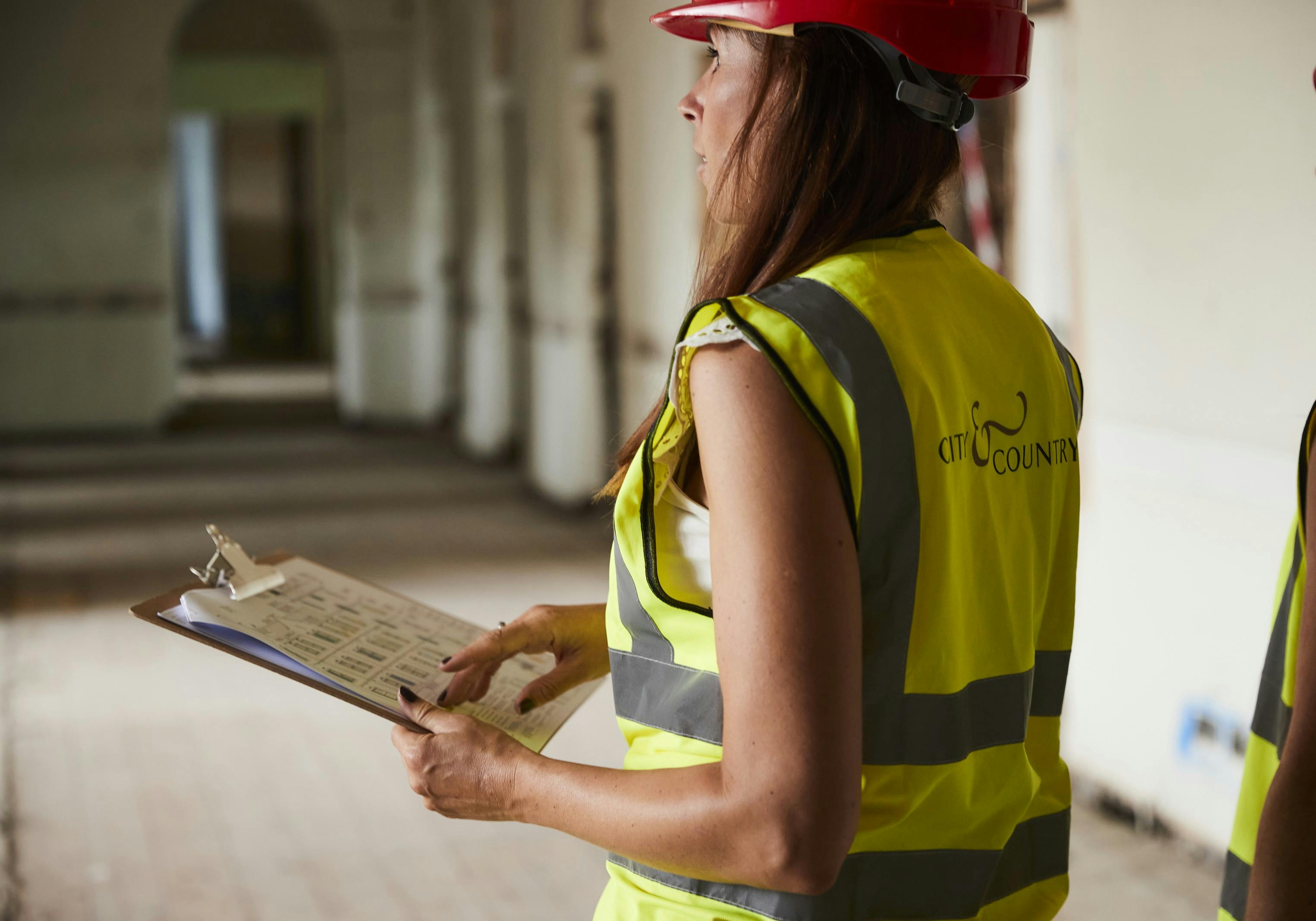 A lady wearing PPE doing a site walk
