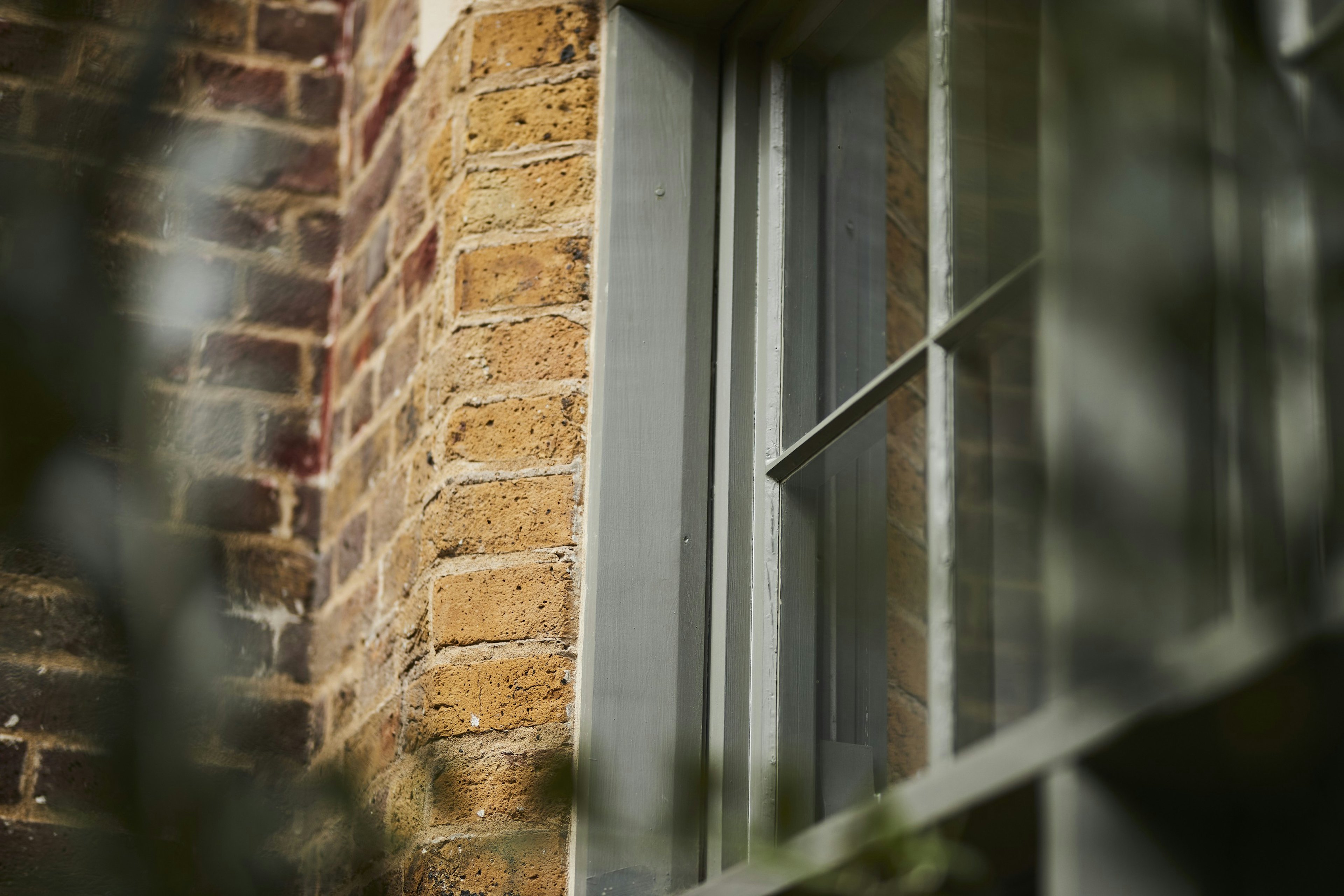 Caption: a close up of a window on a brick building