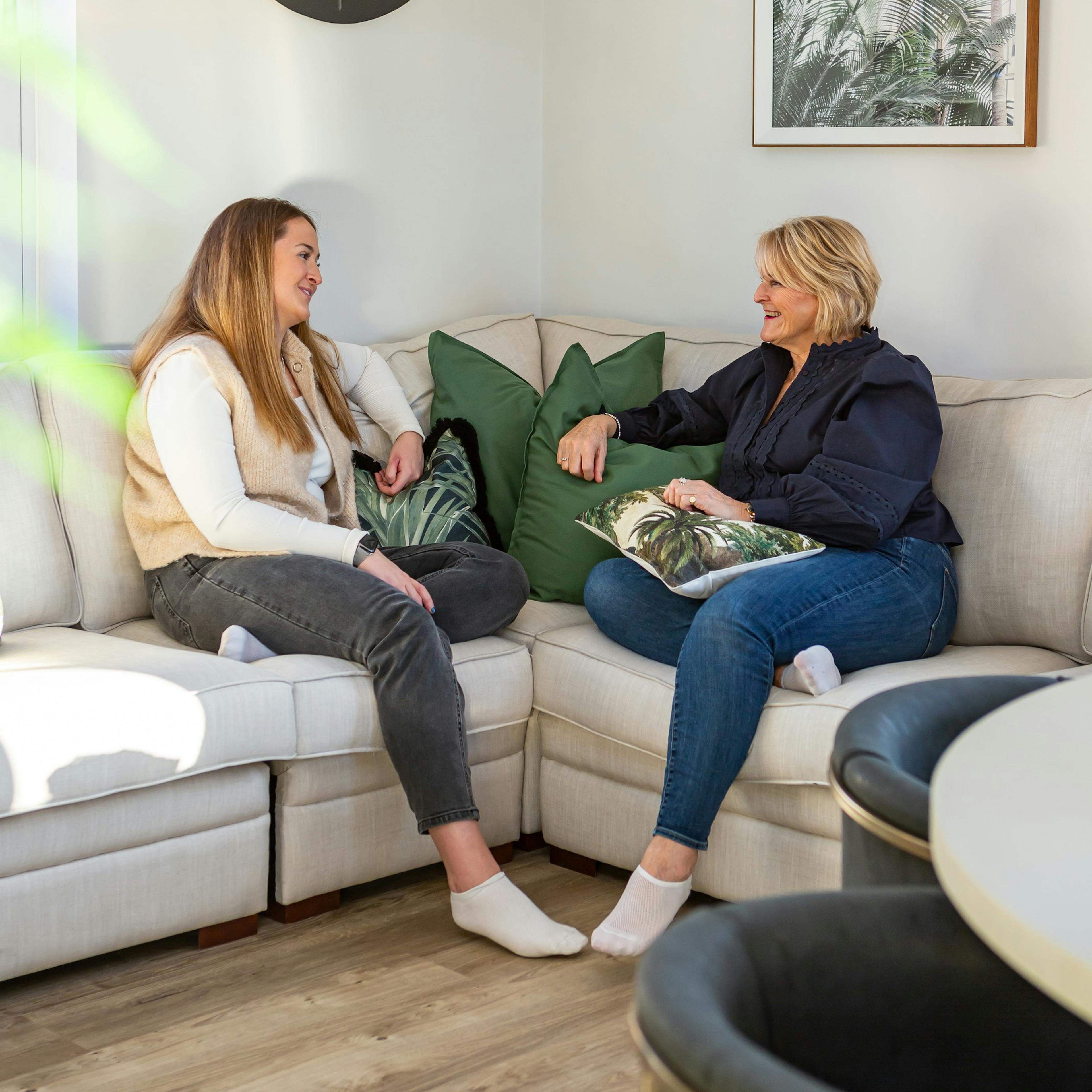 A mother and daughter sitting on a sofa
