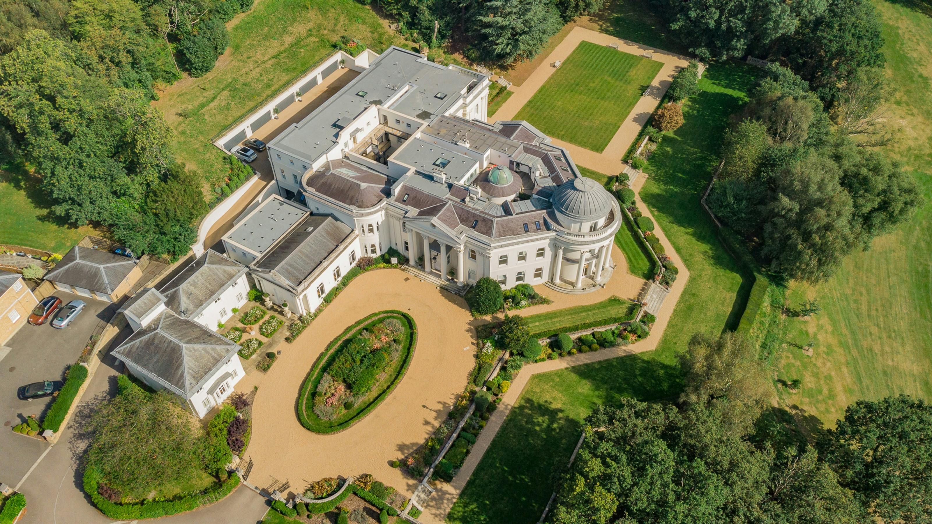 Caption: an aerial view of a large white mansion