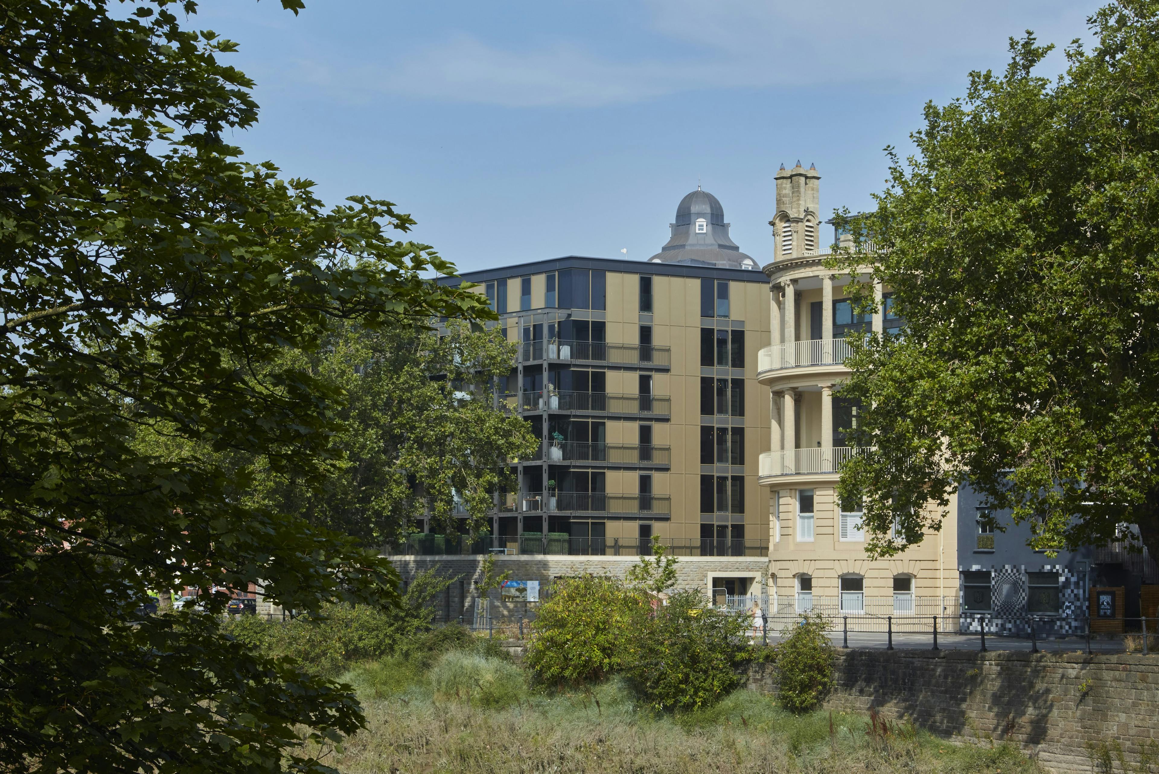 Caption: a tall building with a clock on the top of it