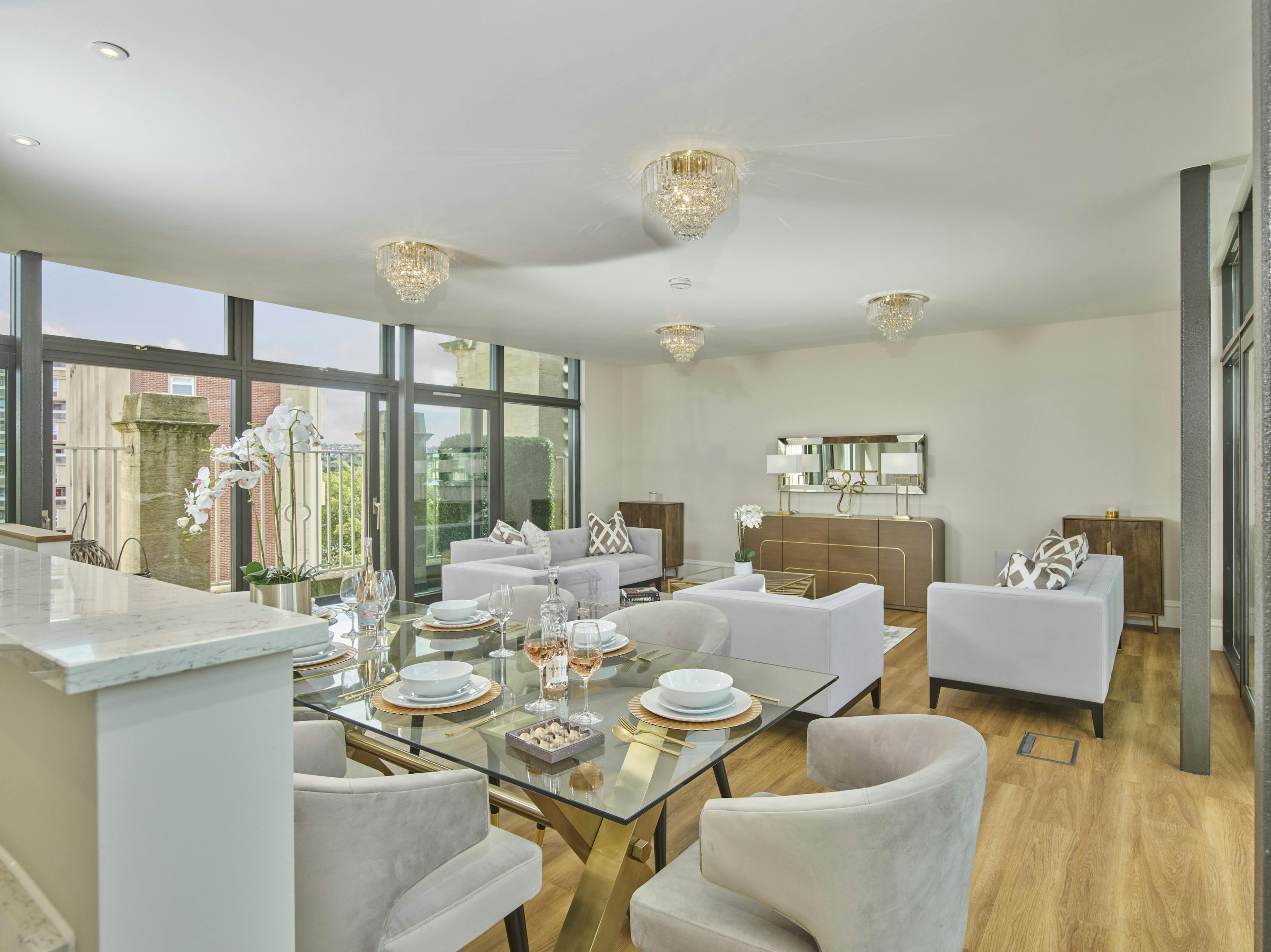 Caption: a living room filled with furniture and a large window