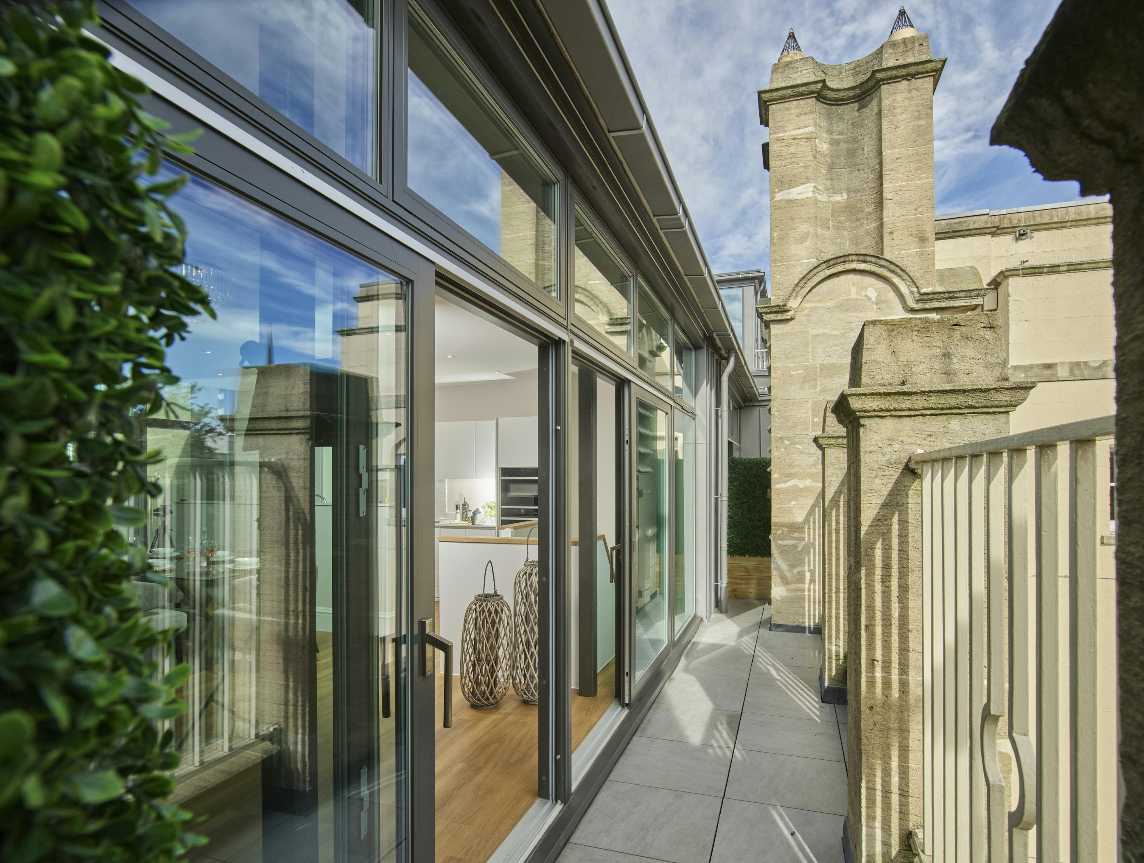 Caption: a balcony with a clock tower in the background