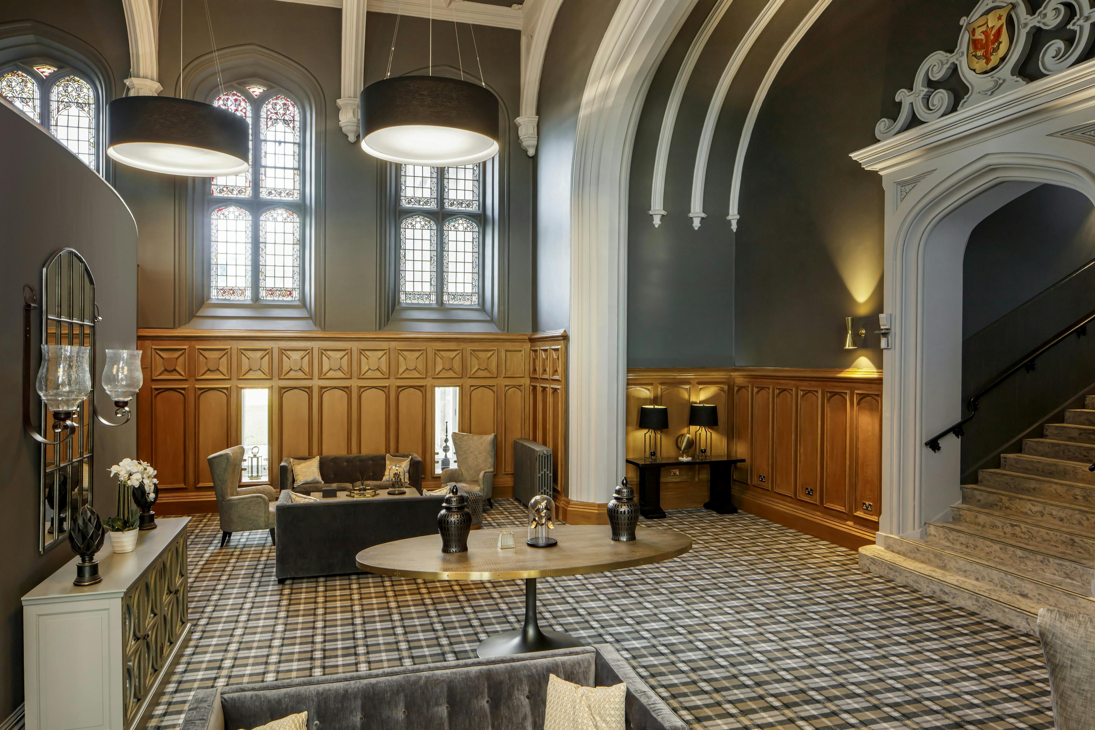 Caption: a living room with a lot of furniture and windows