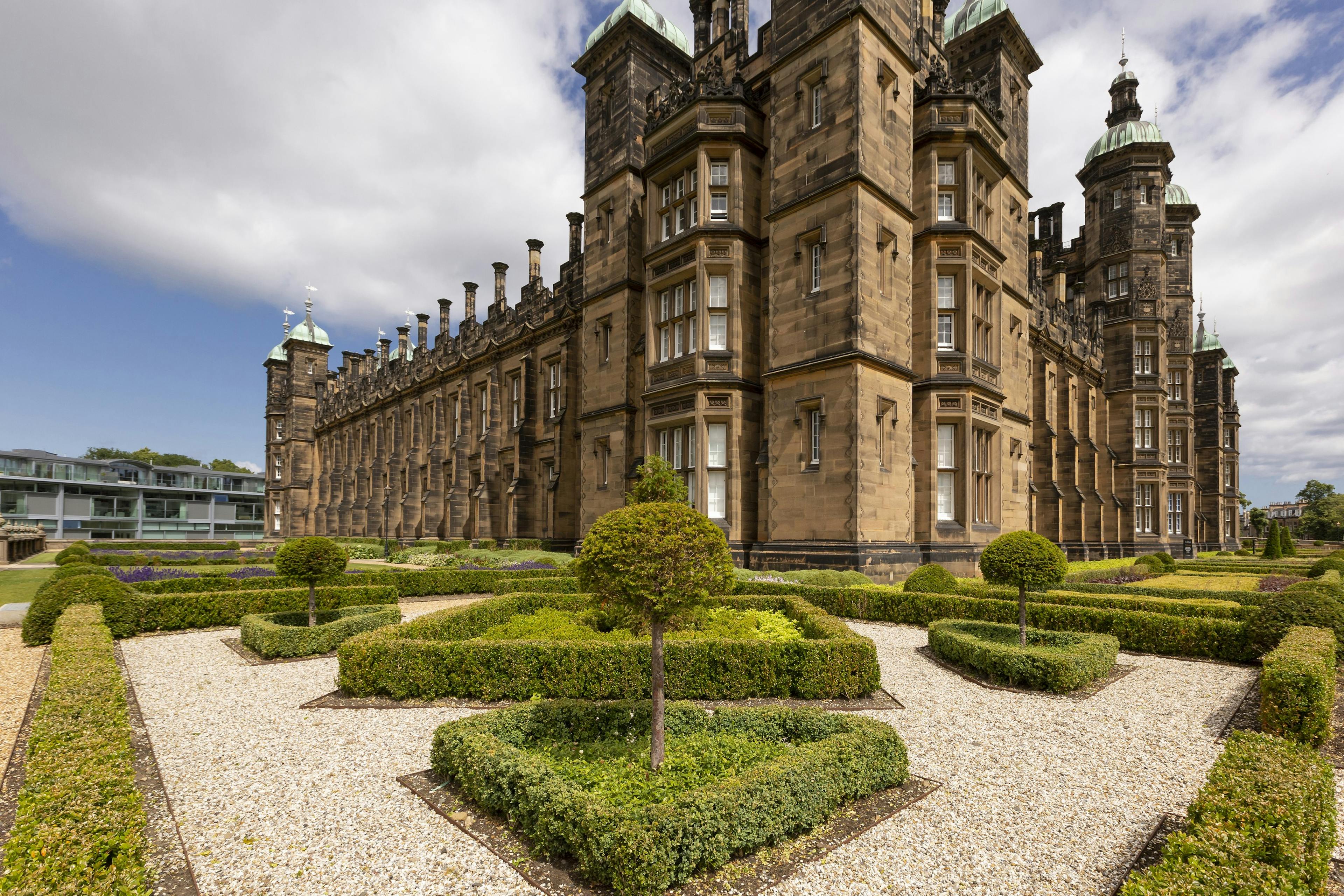 Caption: a large building with a garden in front of it
