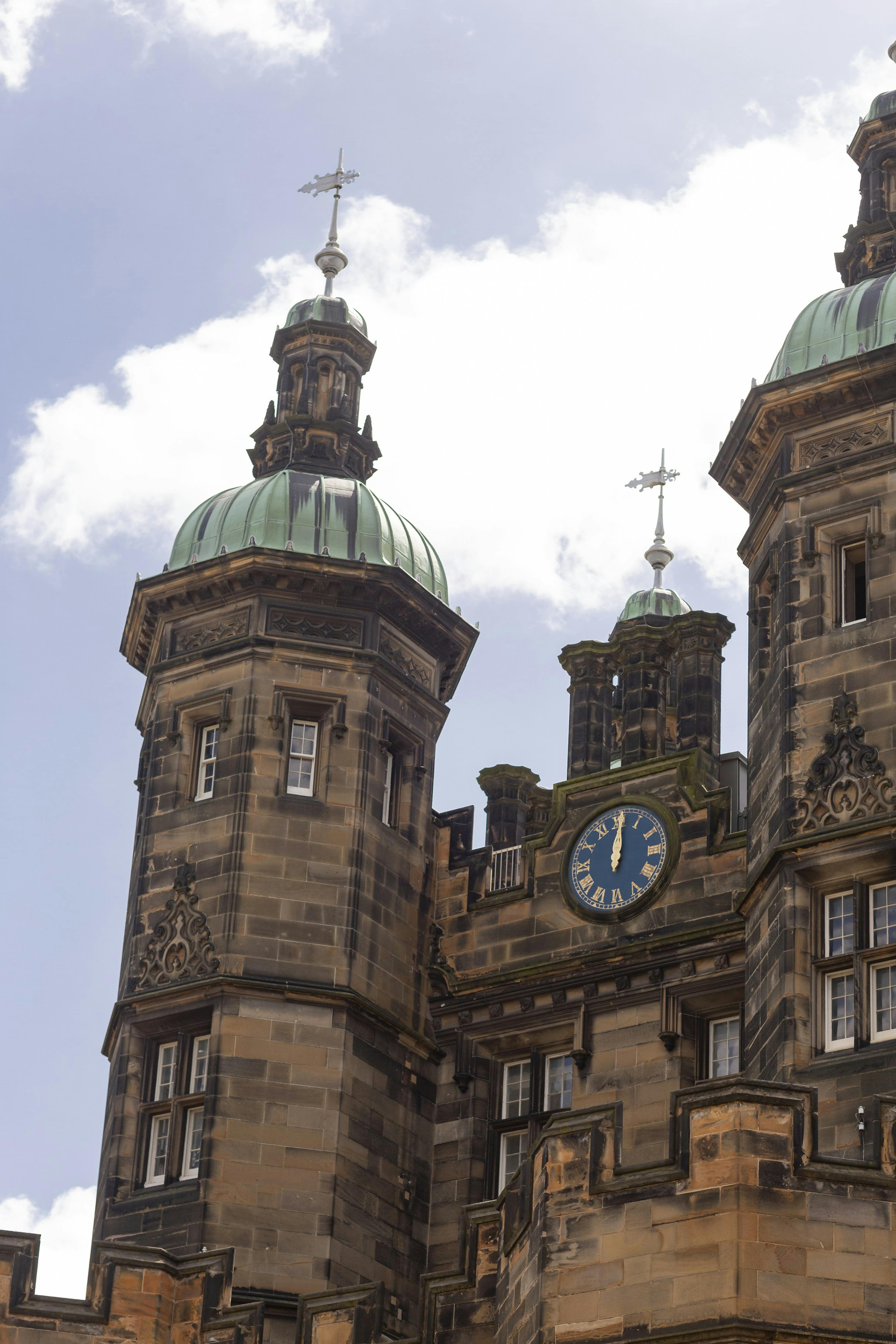 Caption: a large building with a clock on the front of it