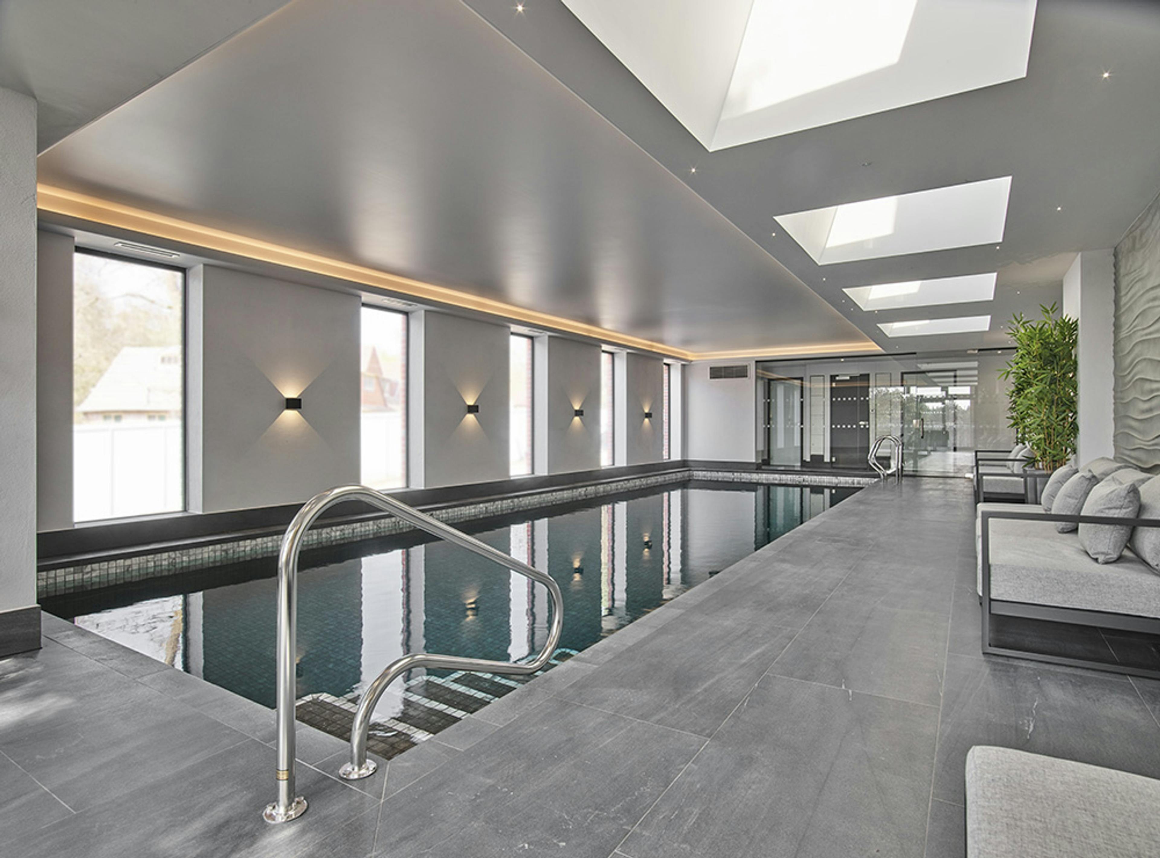 Caption: a large indoor swimming pool with a skylight