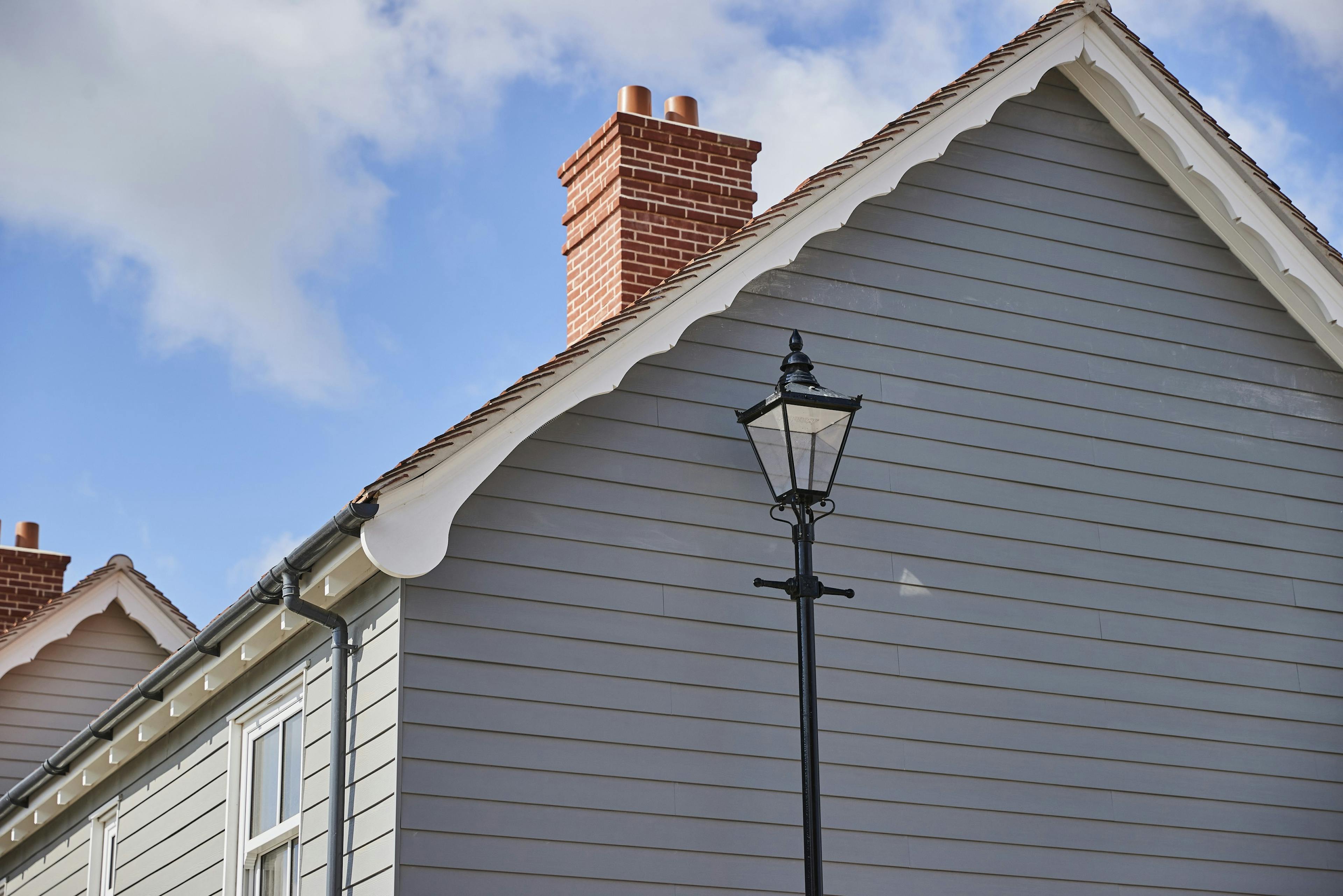 A lamp post next to a wooden clad building