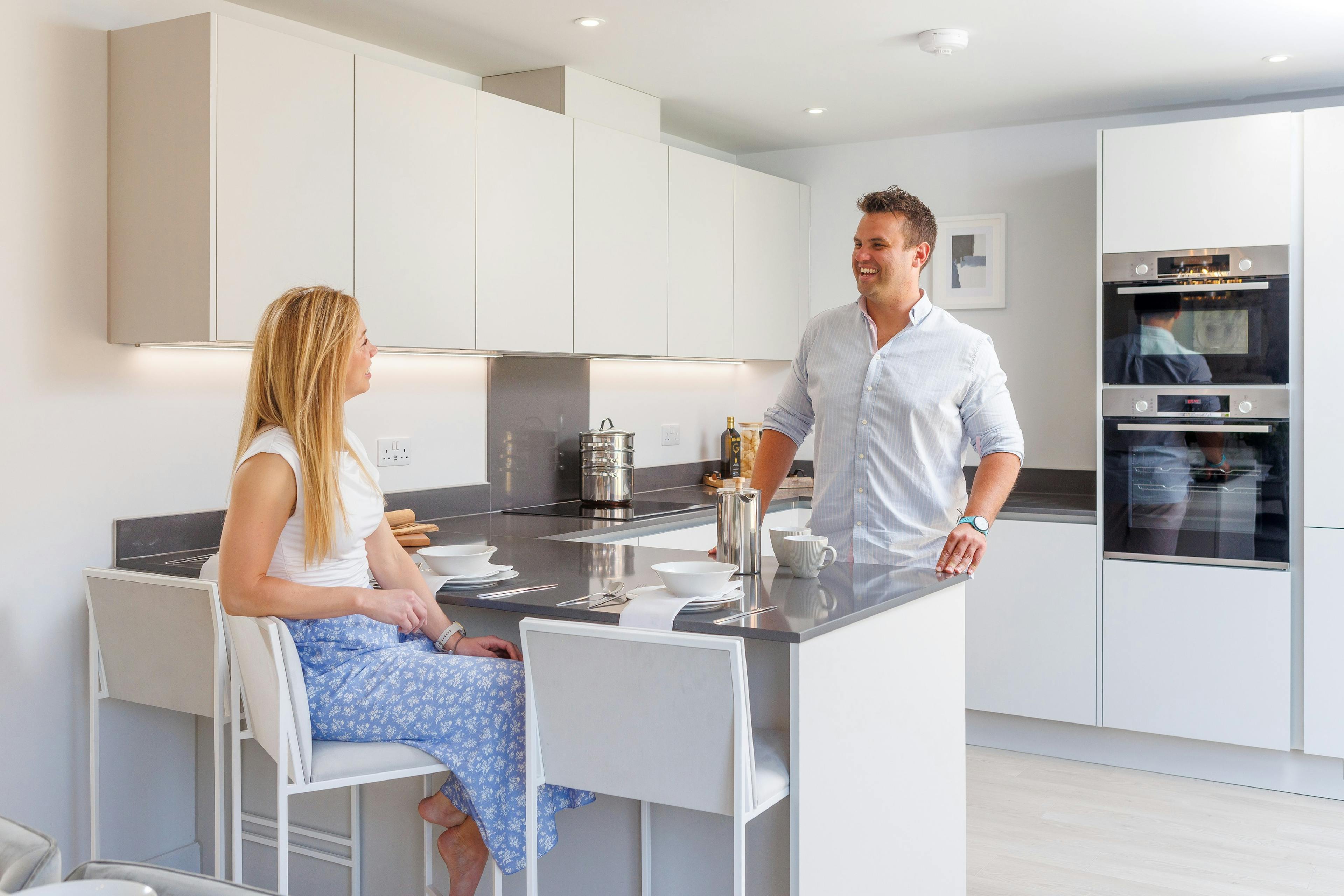 A happy couple laughing in their new kitchen