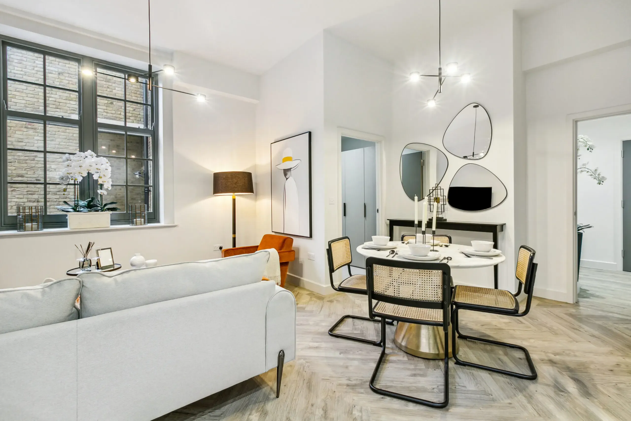 Caption: a living room with a couch a table and chairs