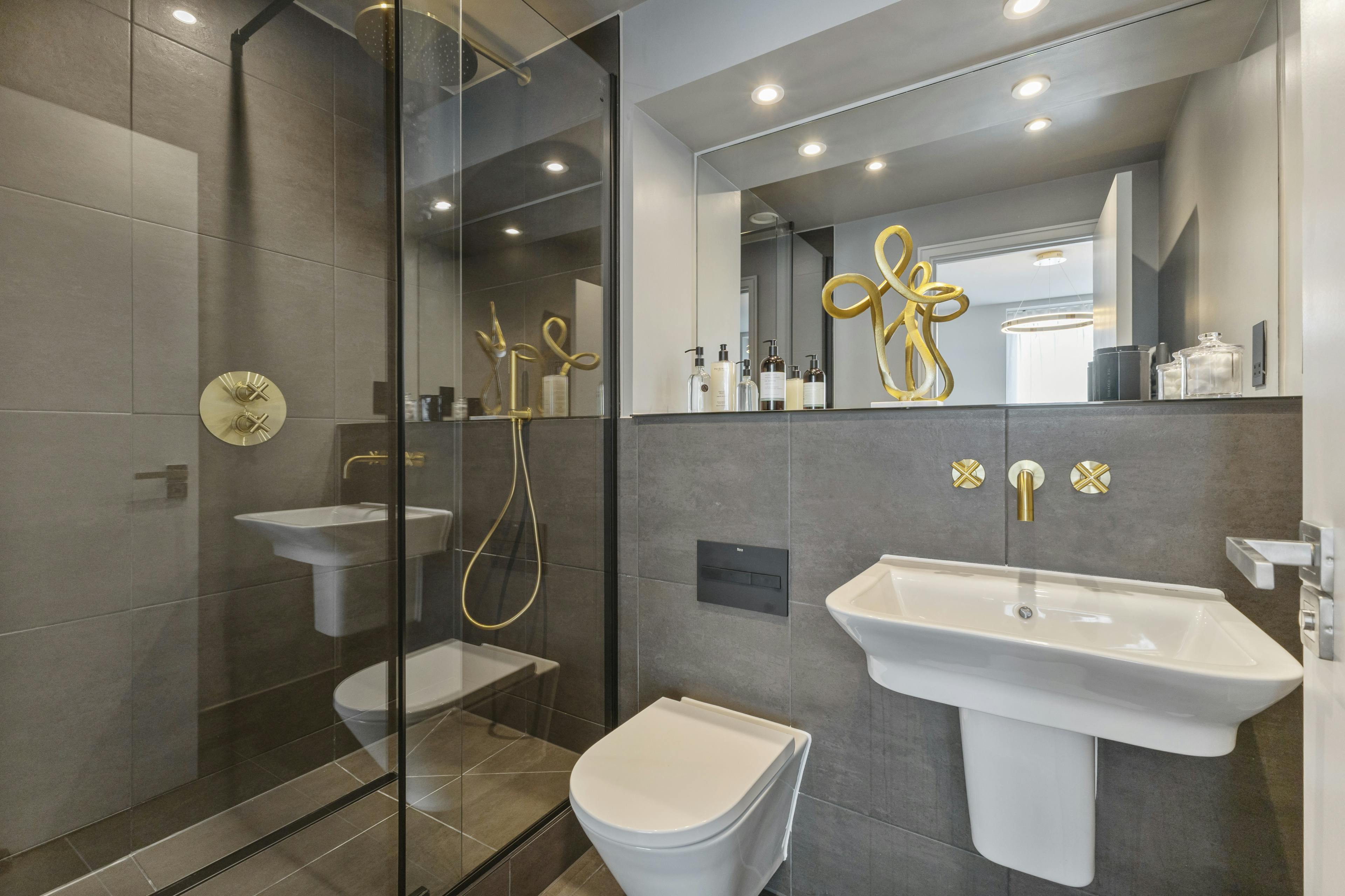 Caption: a bathroom with a sink, toilet, and shower