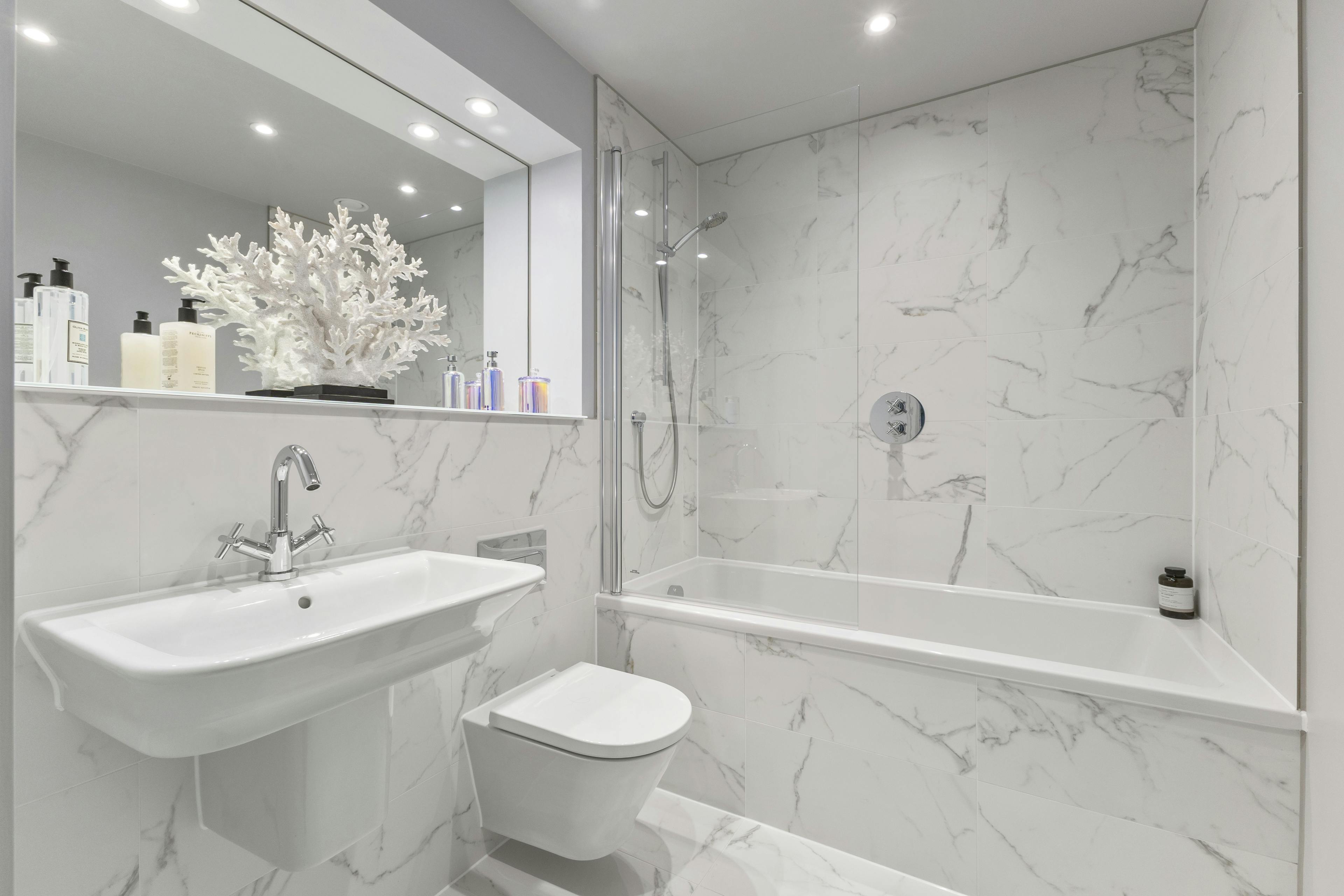 Caption: a bathroom with a toilet, sink, and bathtub