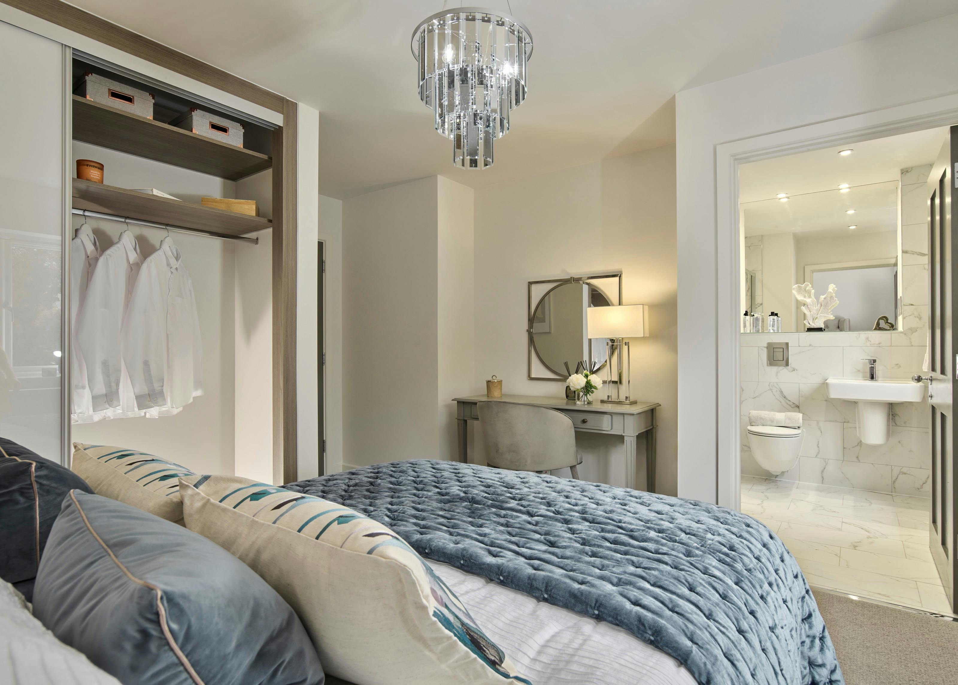 Caption: a bedroom with a large bed and a chandelier