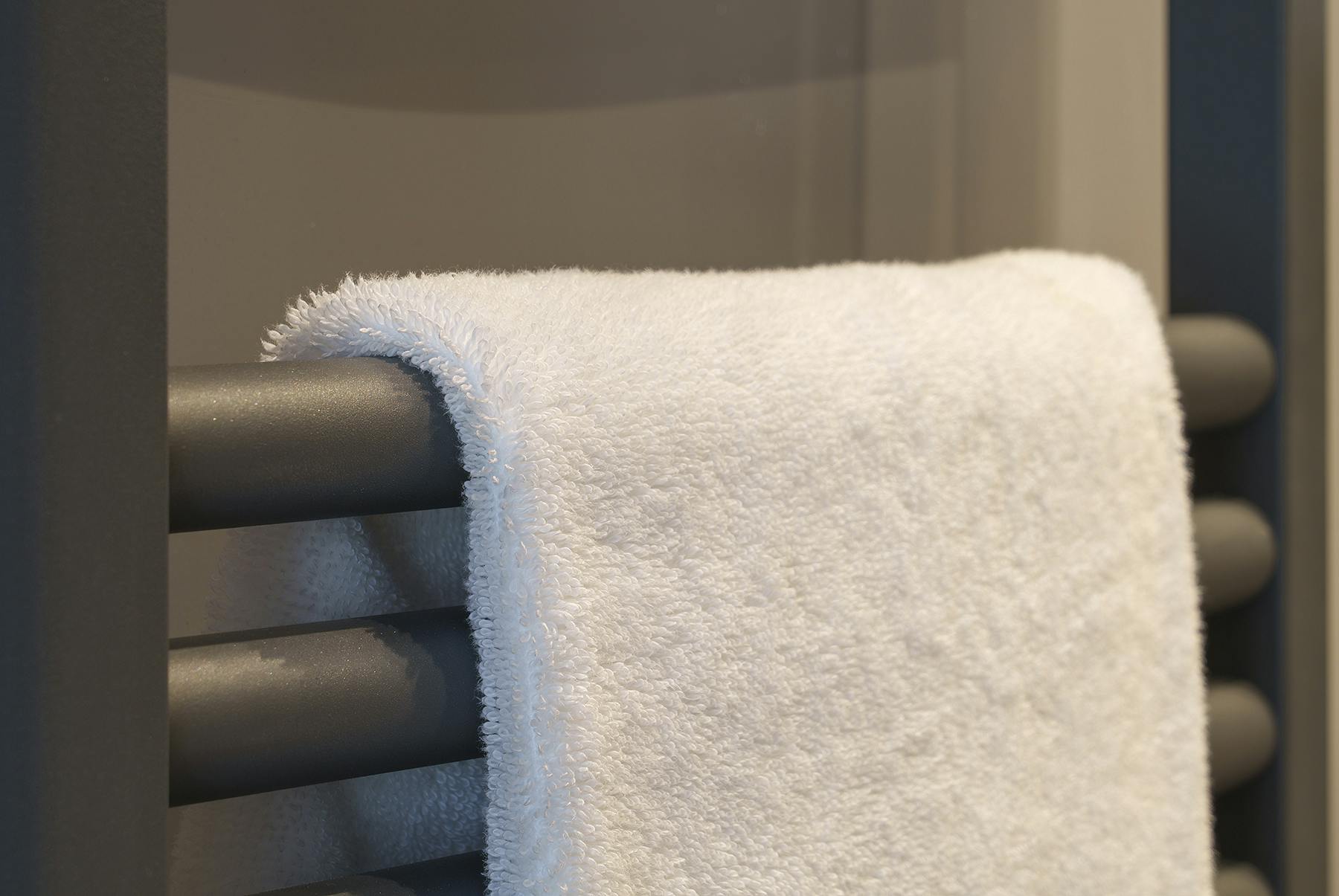 Caption: a close up of a towel rack in a bathroom