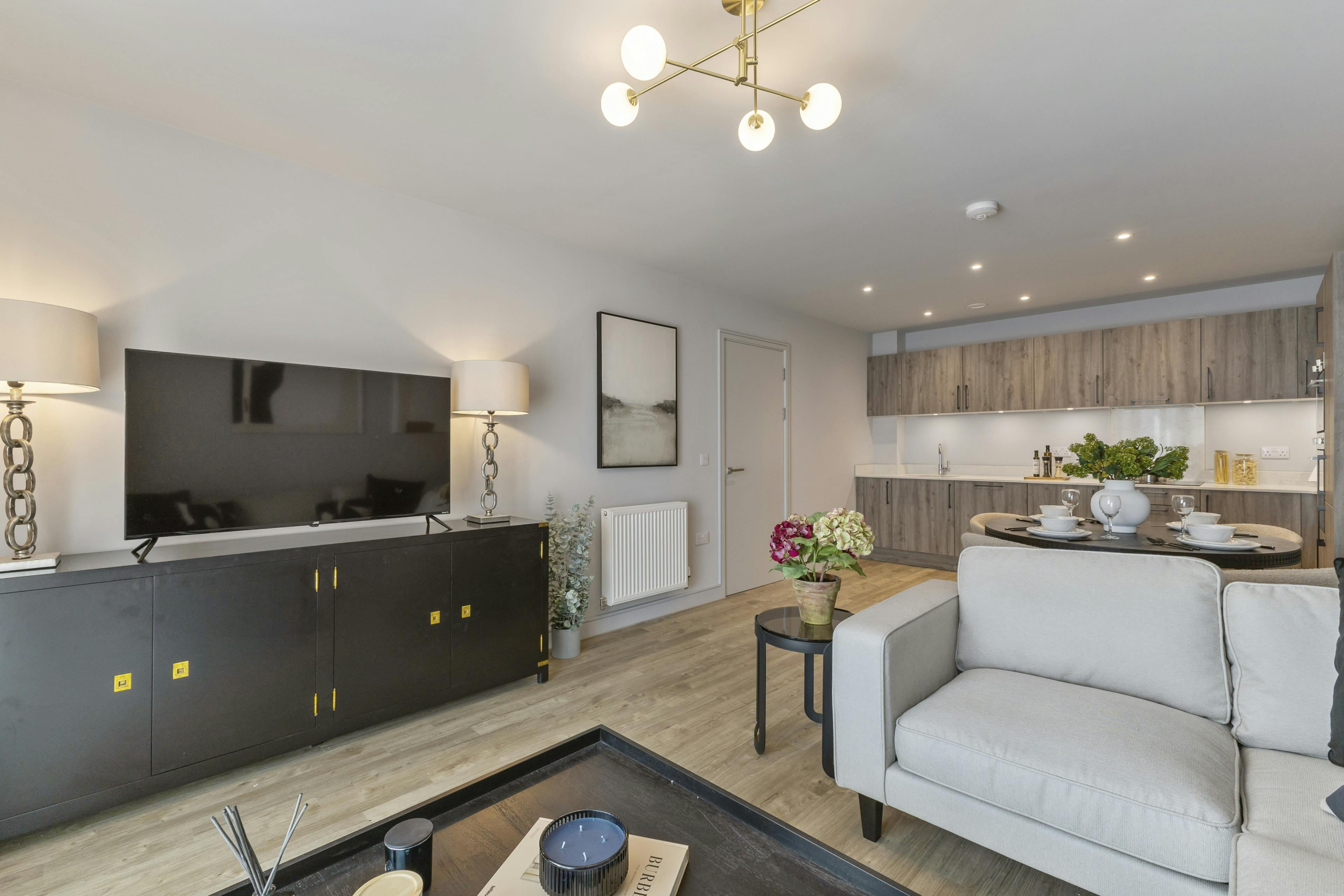 Caption: a living room filled with furniture and a flat screen tv