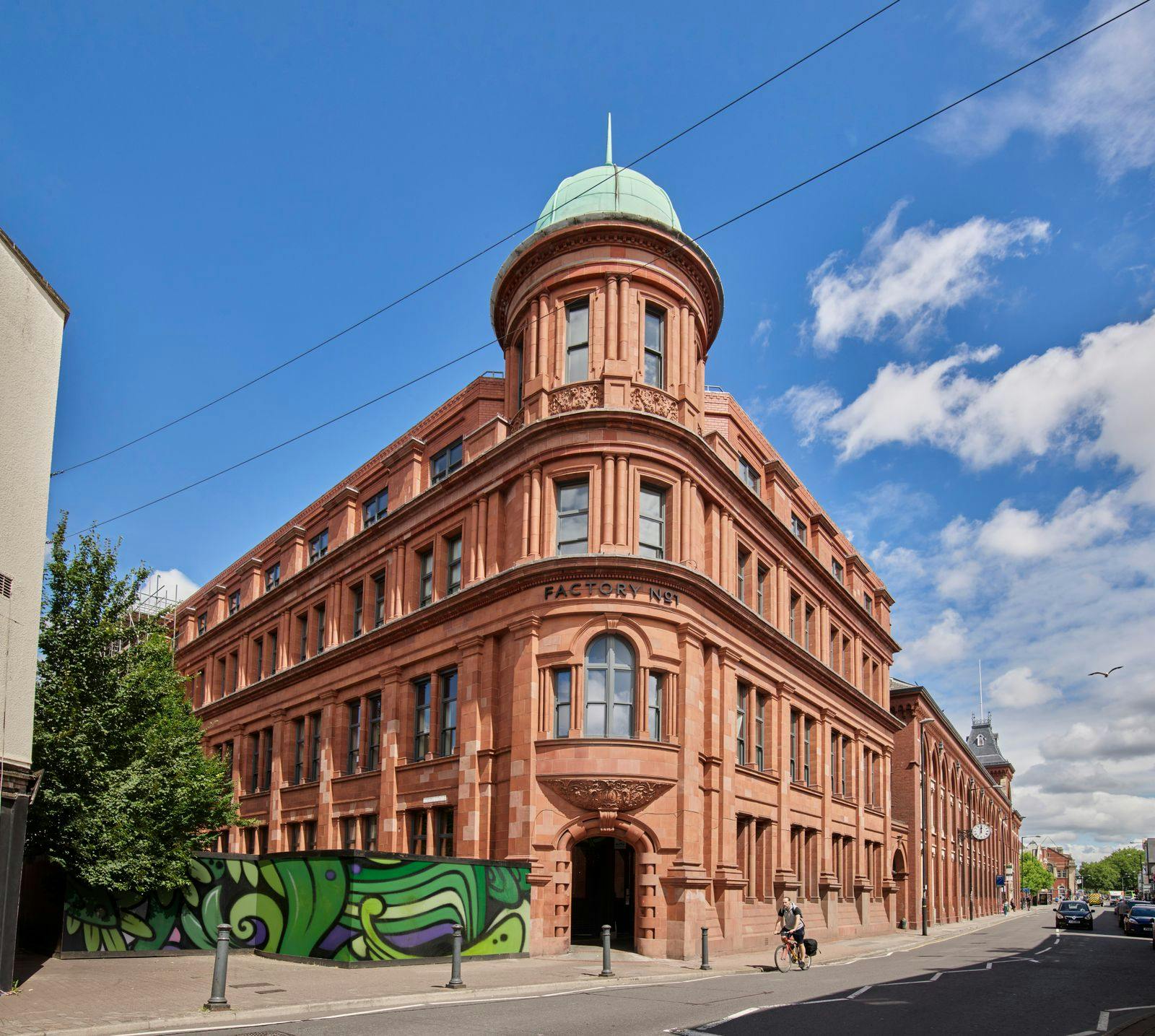 Caption: a large building with a green dome on top of it