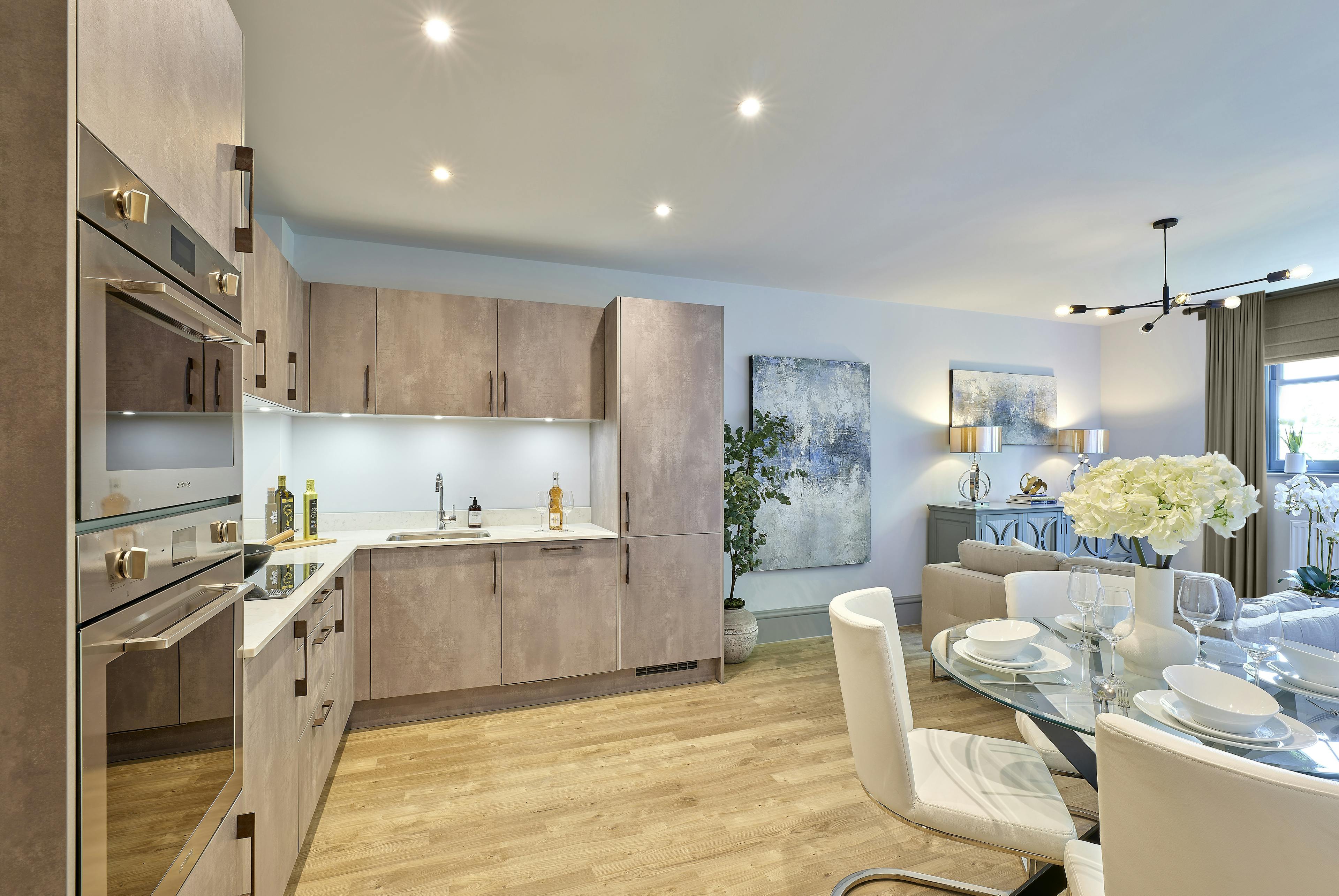 Caption: a kitchen and dining room with a table and chairs