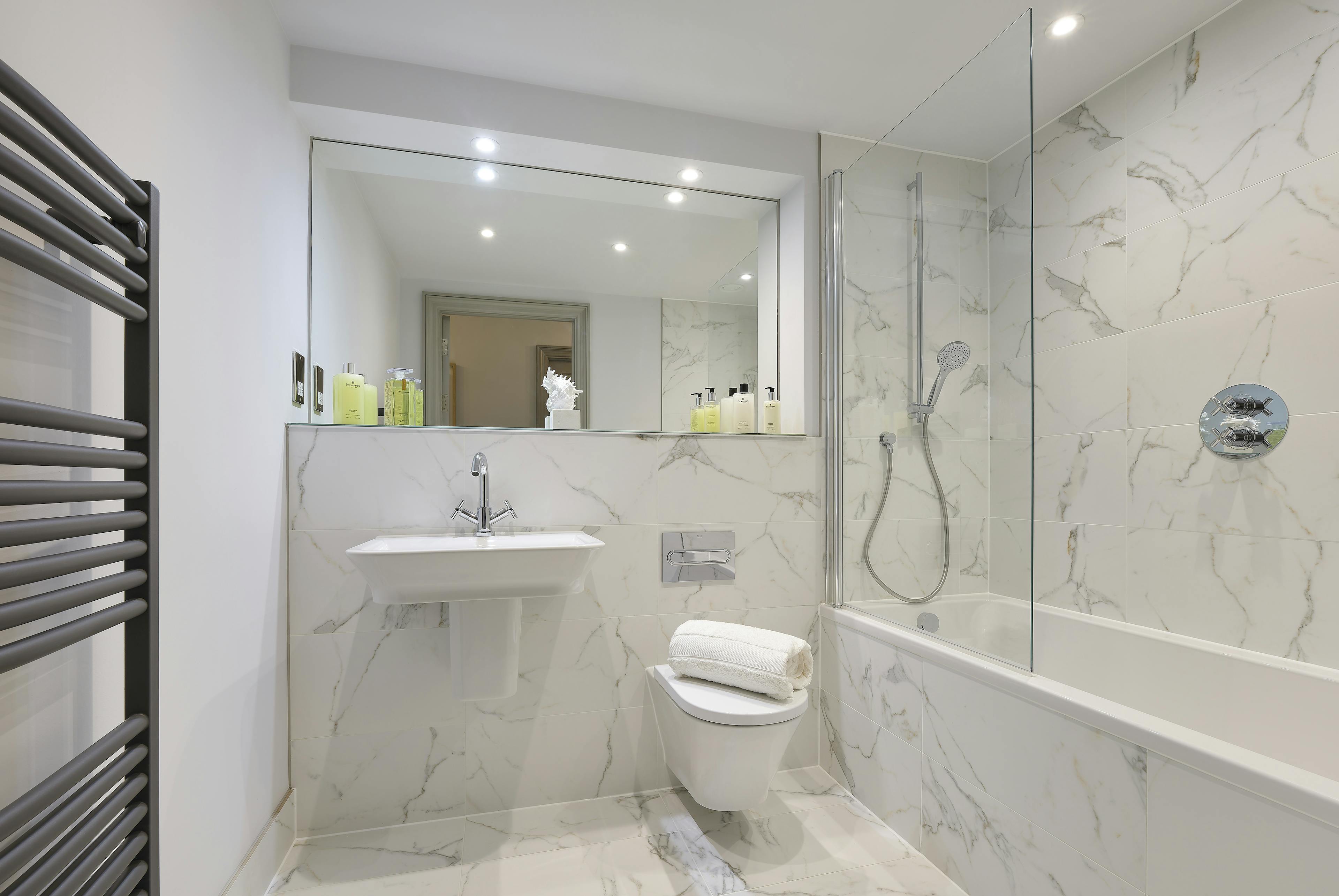 Caption: a bathroom with a white toilet sitting next to a bath tub