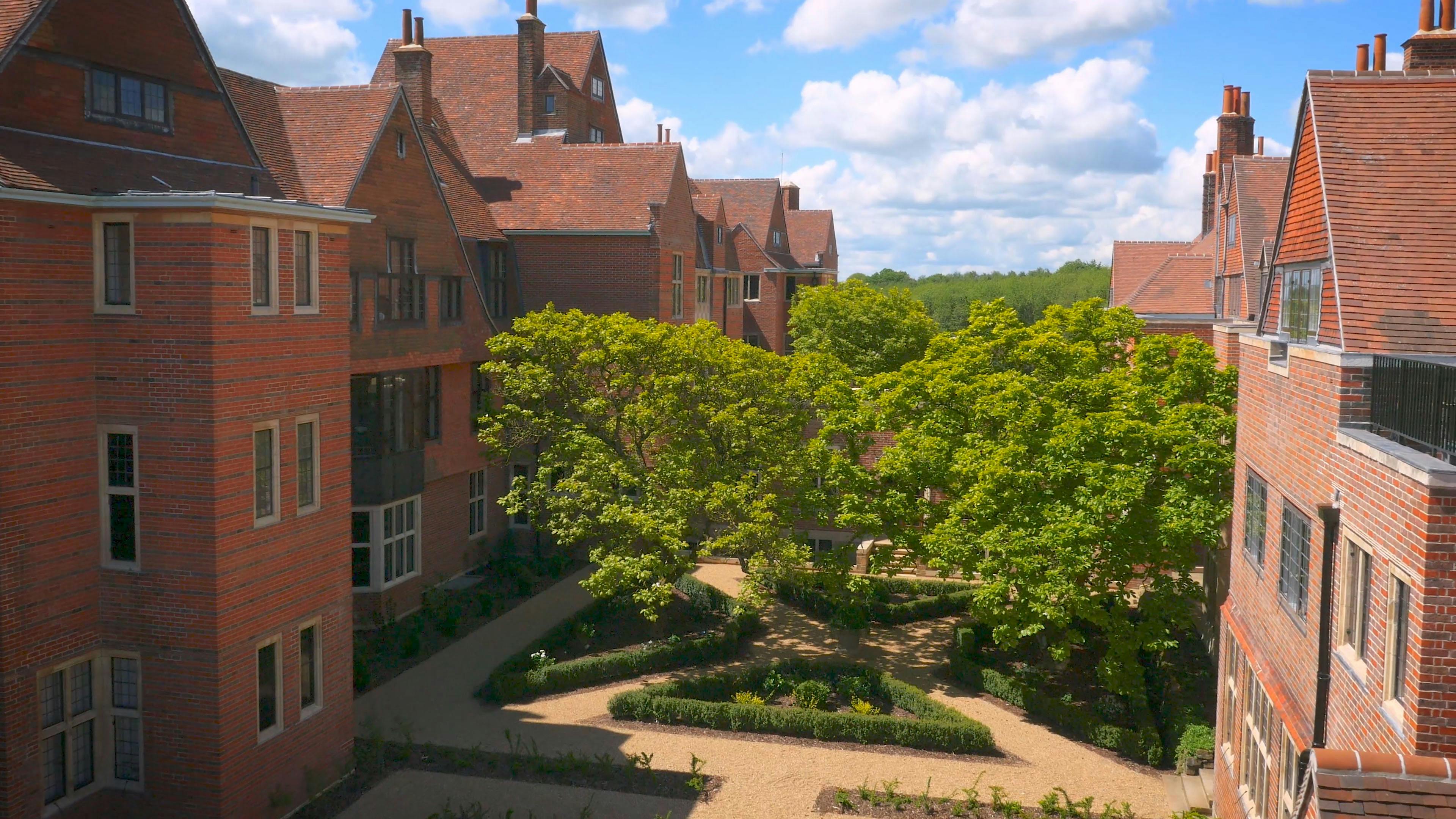 Caption: an aerial view of a building with a garden in front of it