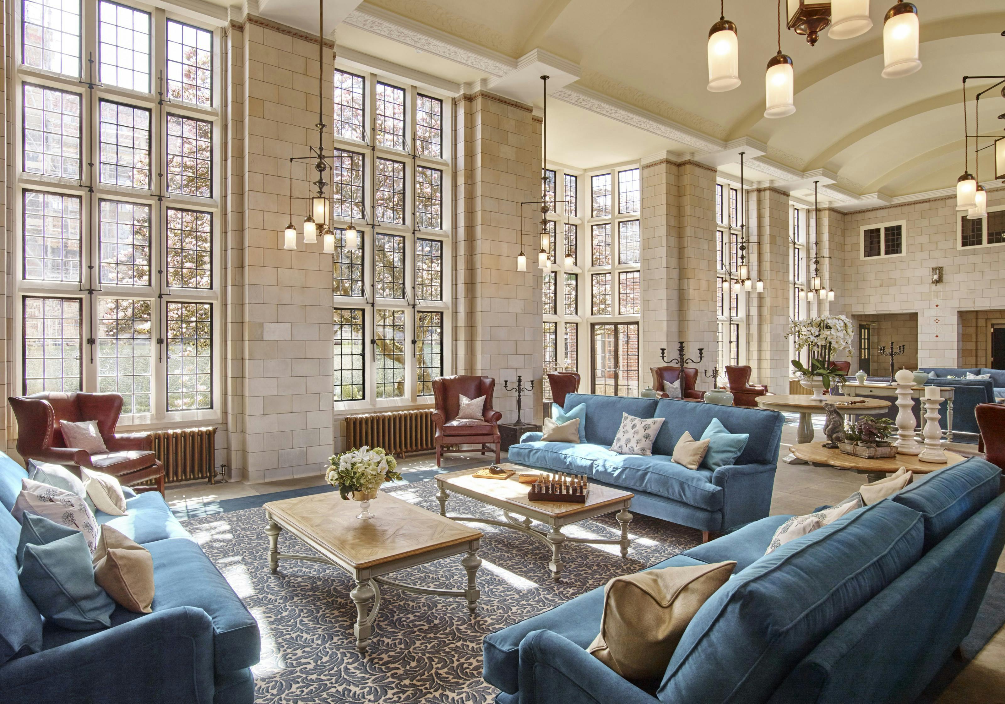 Caption: a living room filled with blue couches and a fire place