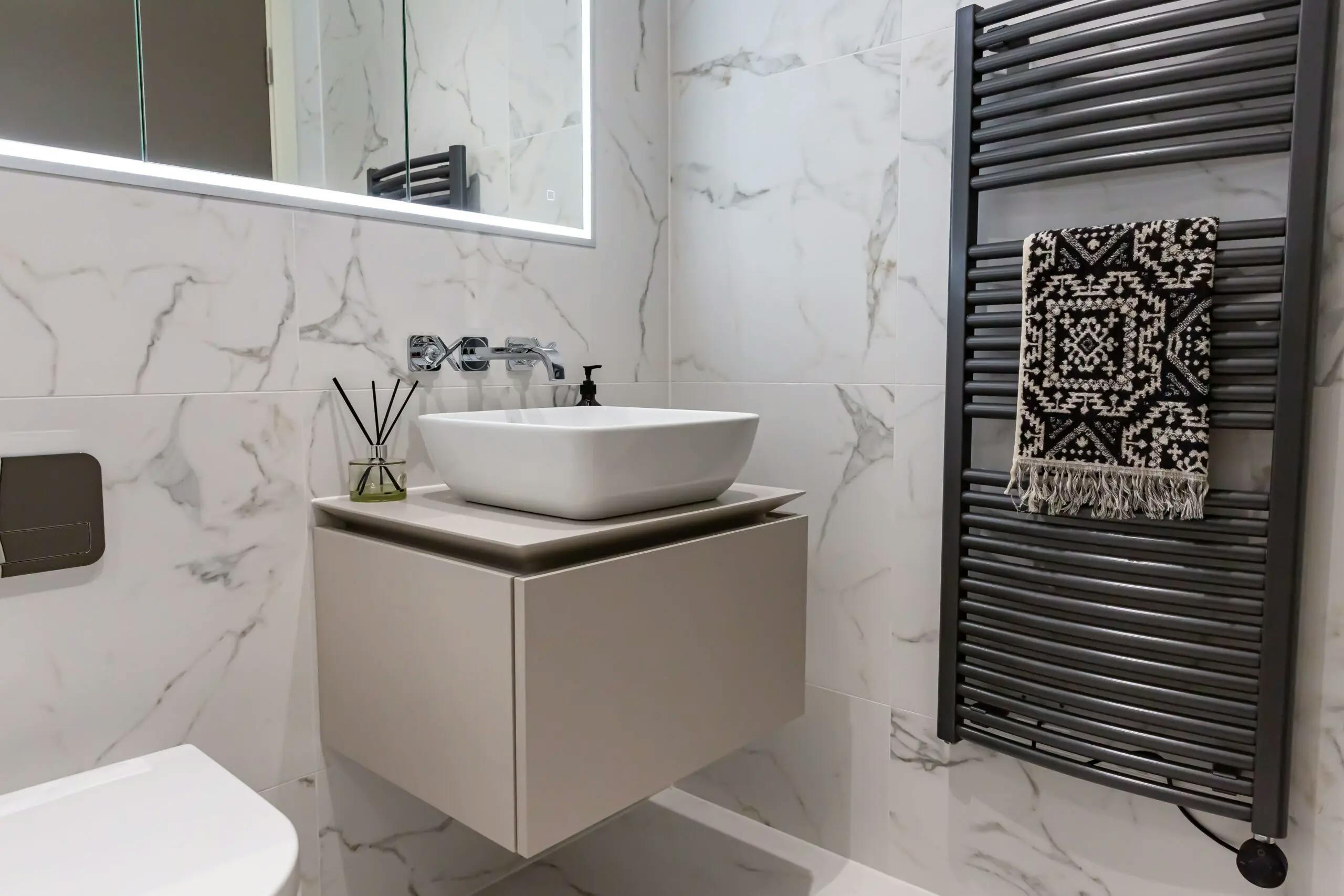 Caption: a bathroom with a sink and a towel rack