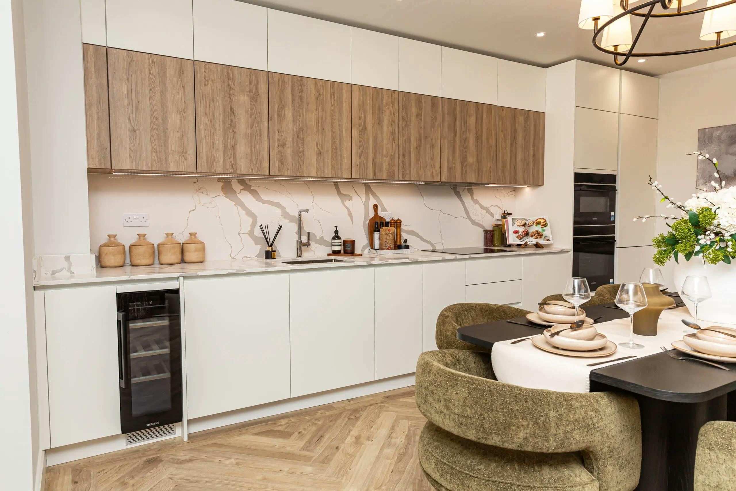 Caption: a kitchen with a dining table and chairs
