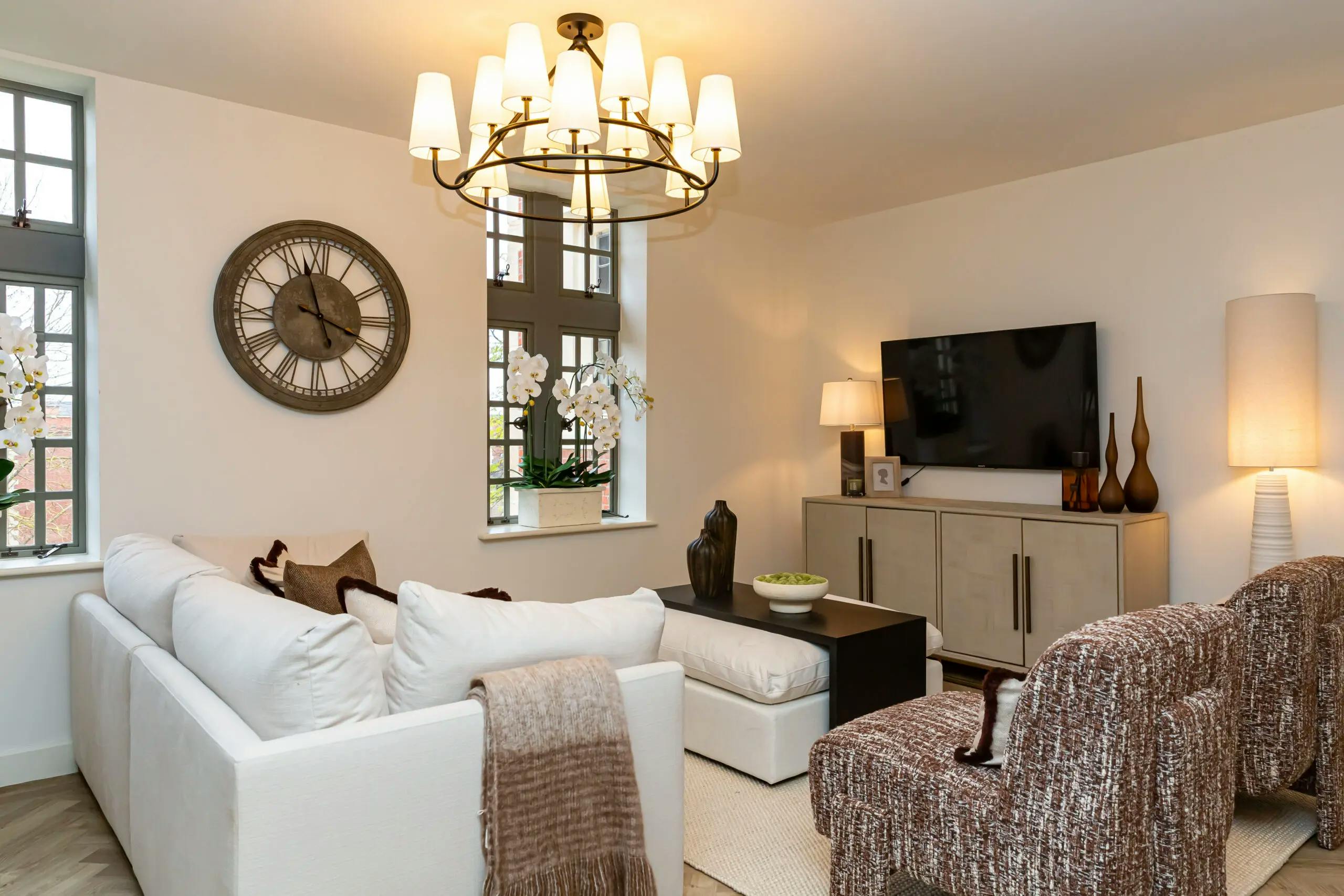 Caption: a living room filled with furniture and a flat screen tv