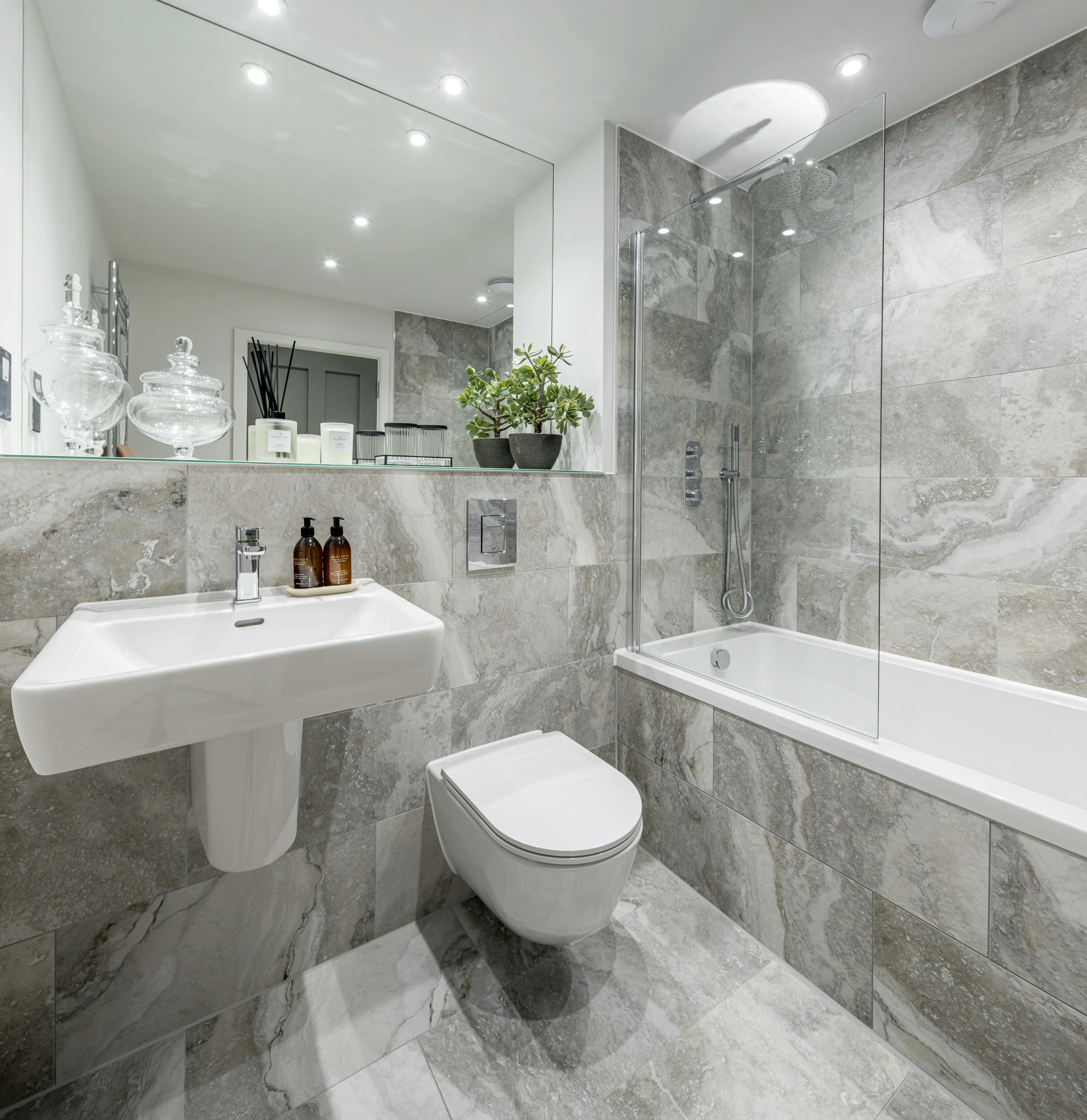 Caption: a bathroom with a toilet, sink, and bathtub