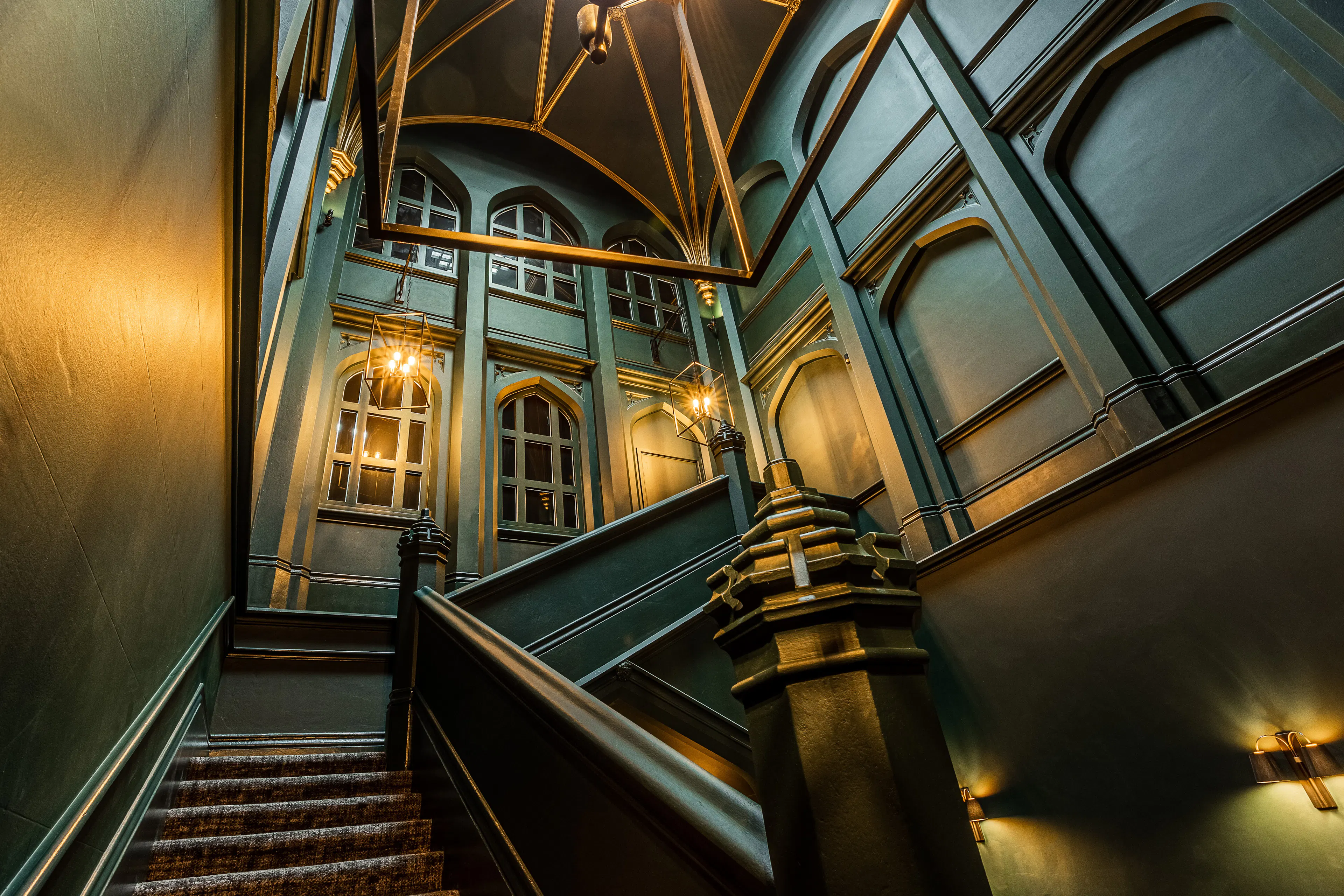 Caption: a staircase with a chandelier and a light fixture