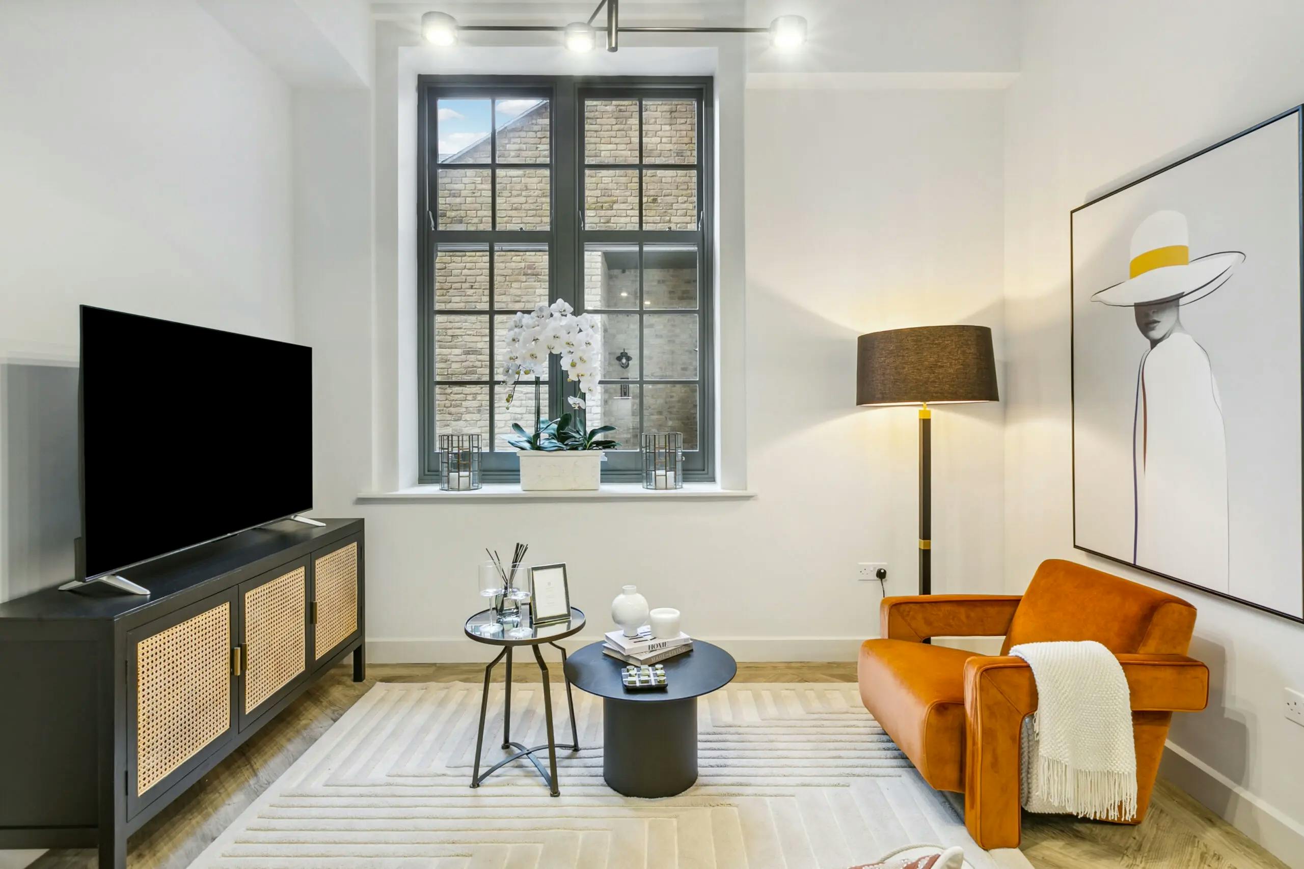 Caption: a living room filled with furniture and a flat screen tv