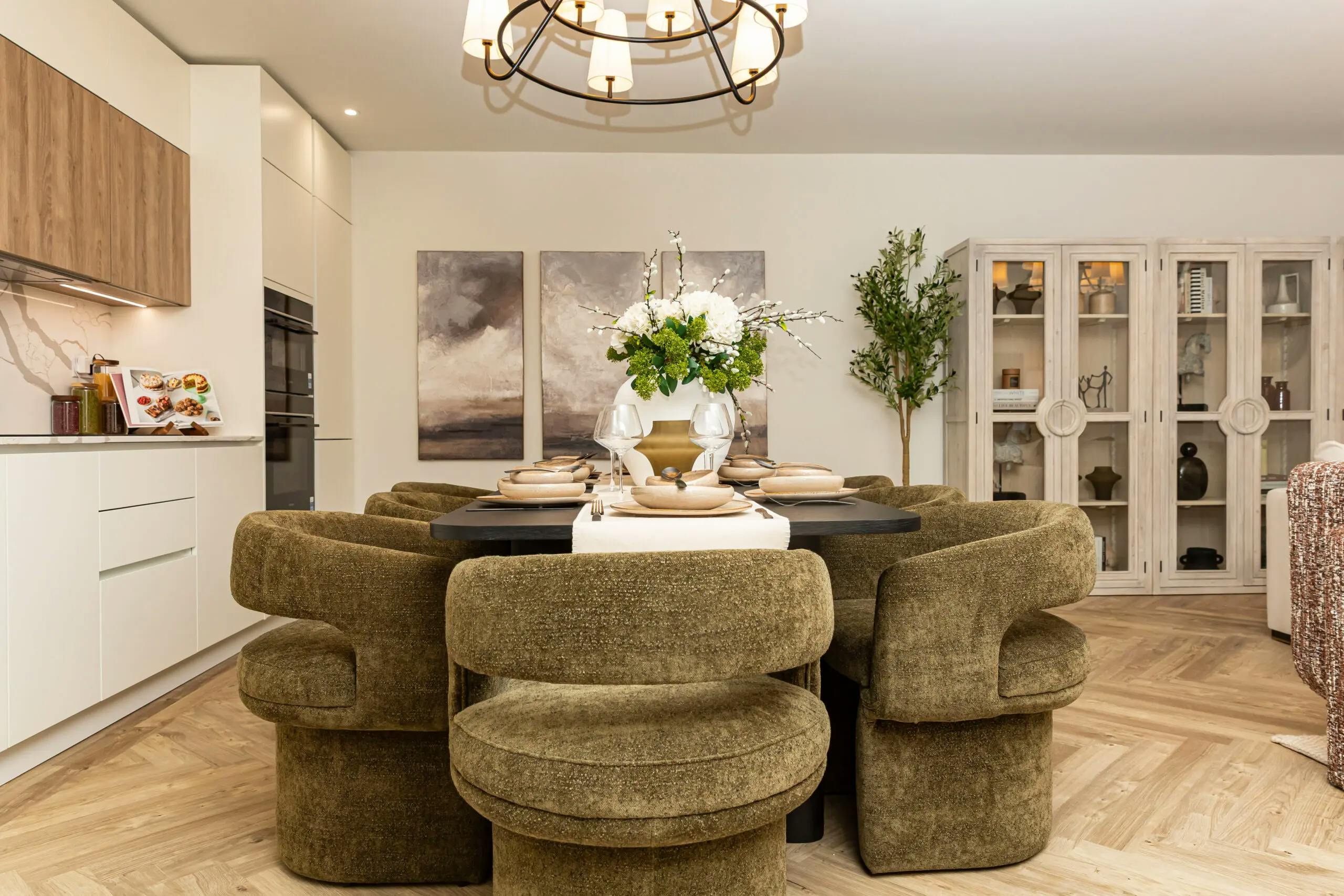 Caption: a dining room table with chairs around it