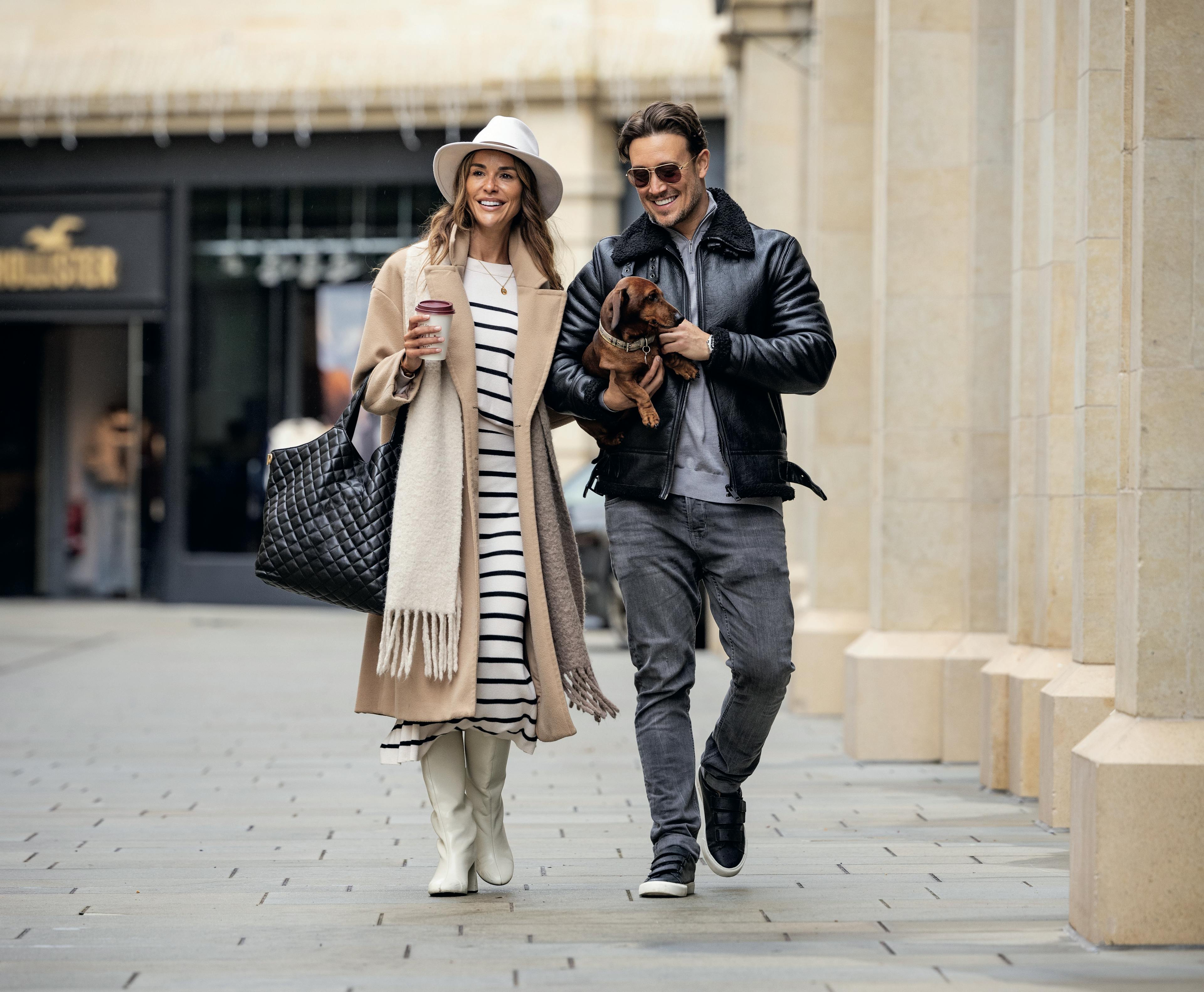 Caption: a man and a woman walking down a street