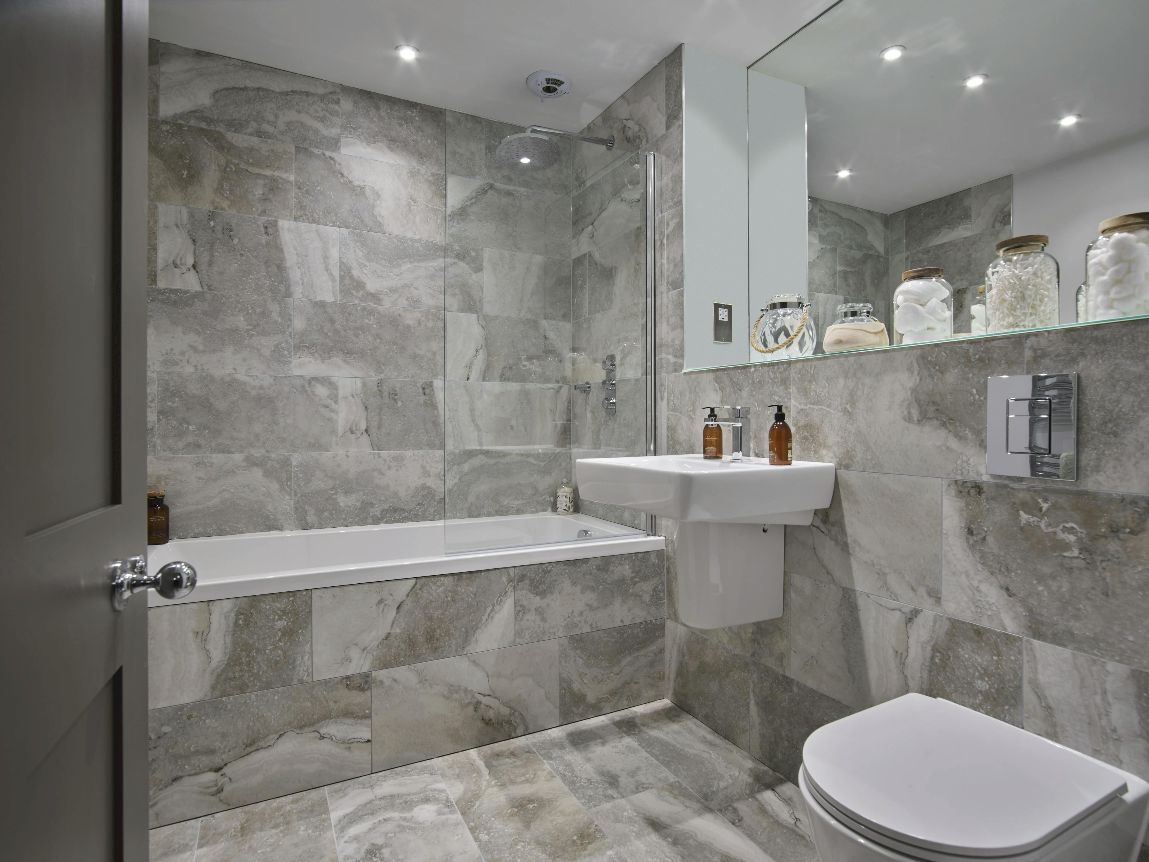 Caption: a white toilet sitting next to a white bath tub