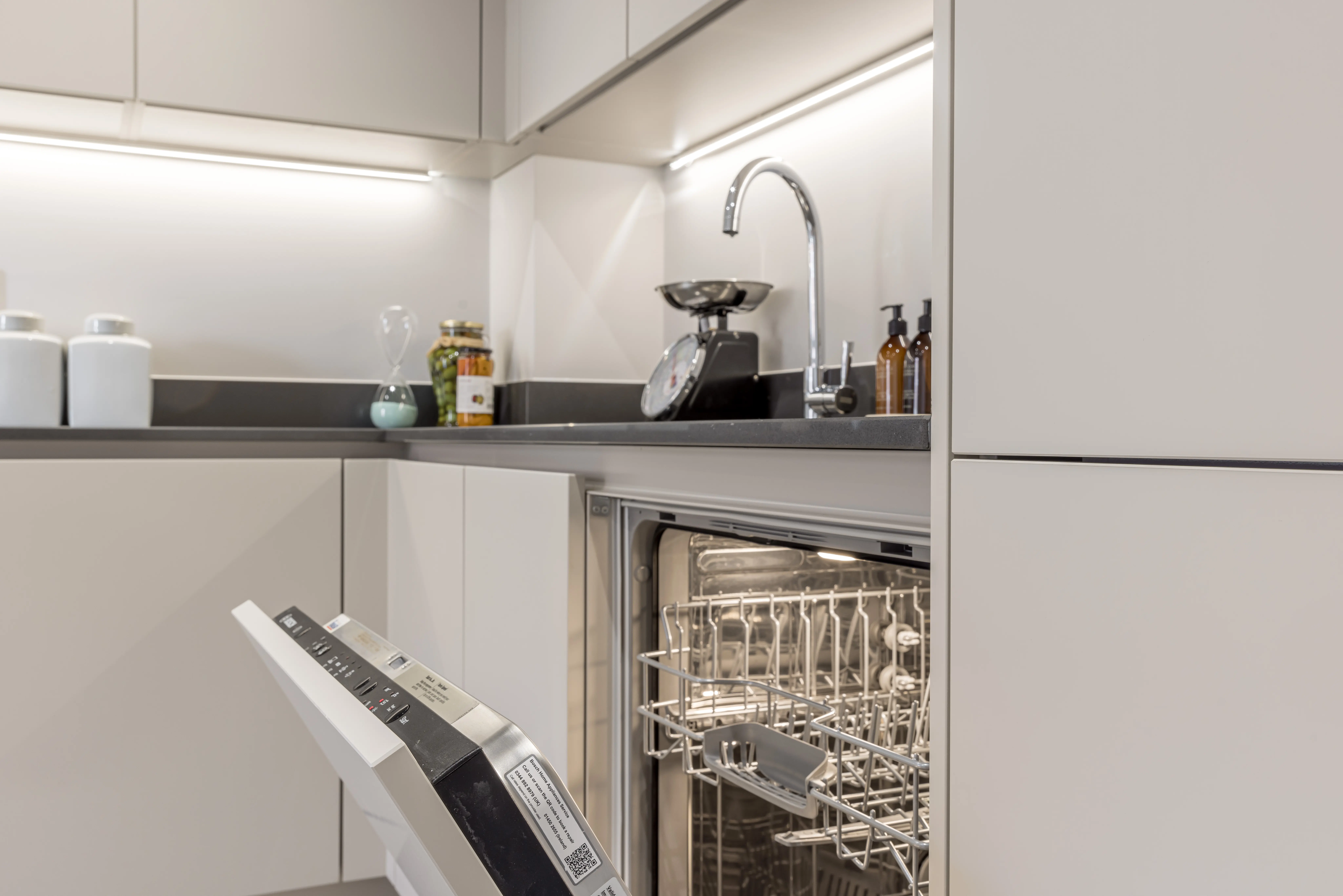 Caption: a dishwasher that is open in a kitchen