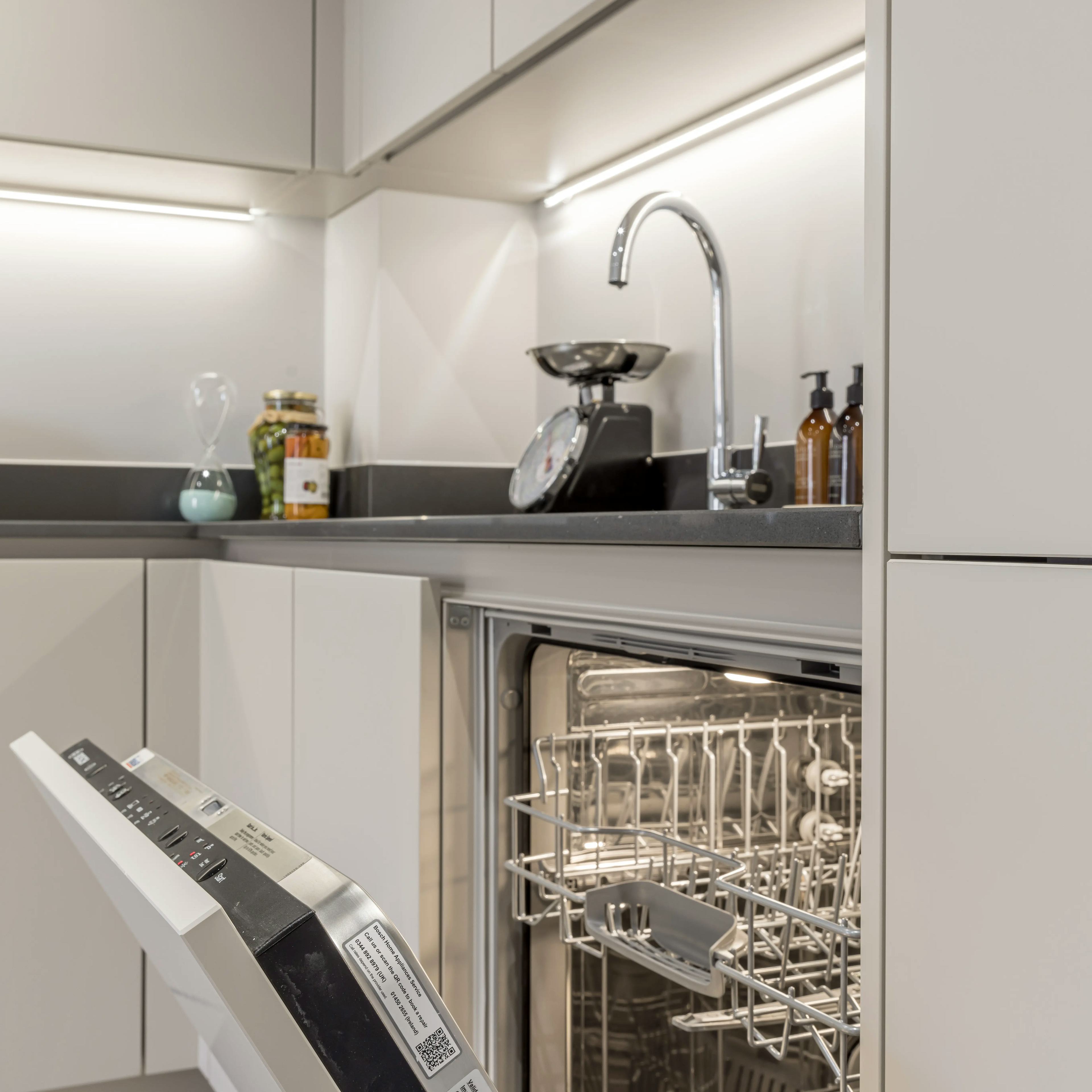 Caption: a dishwasher that is open in a kitchen