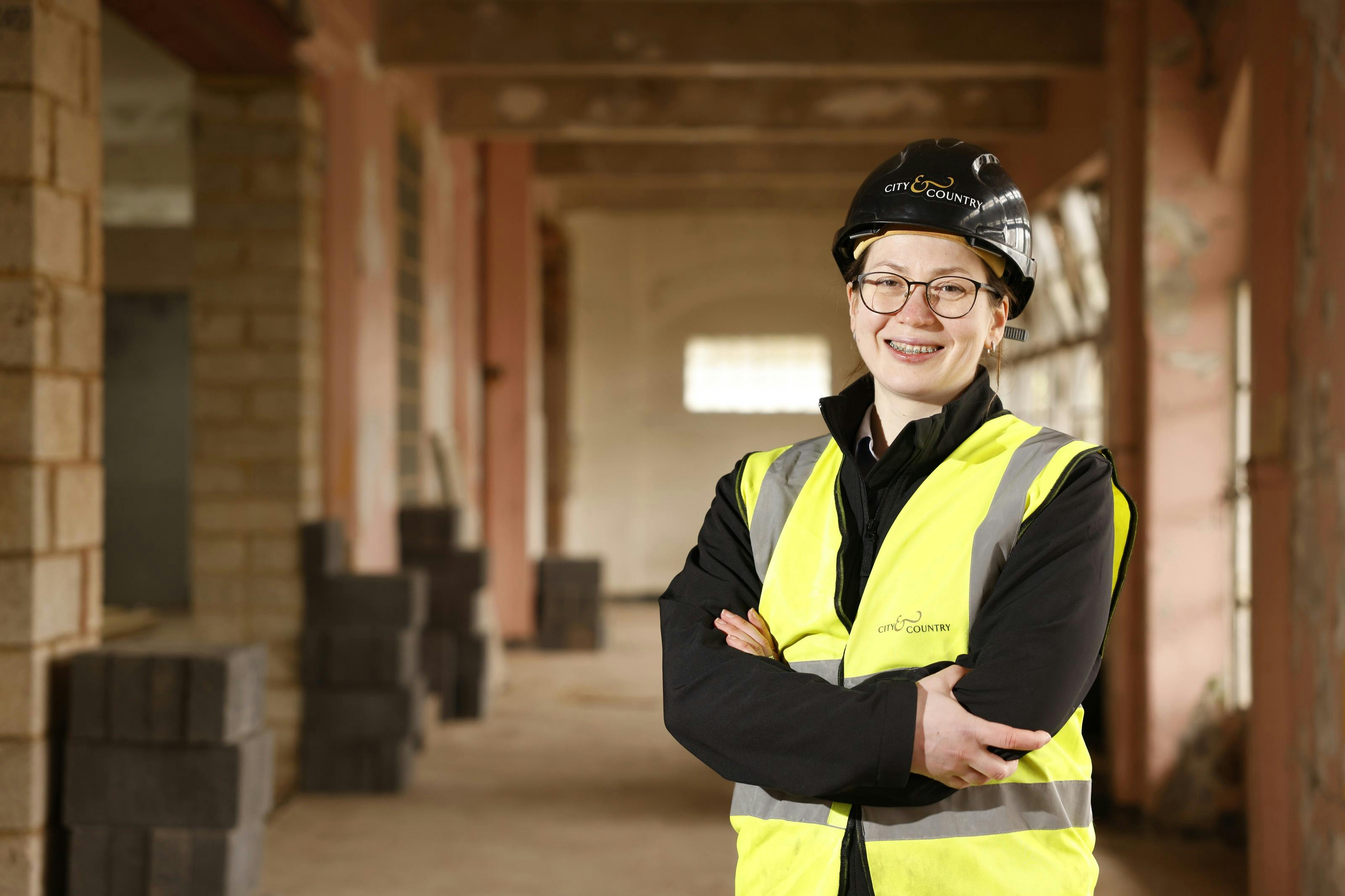 A lady on a building suite wearing protective equipment