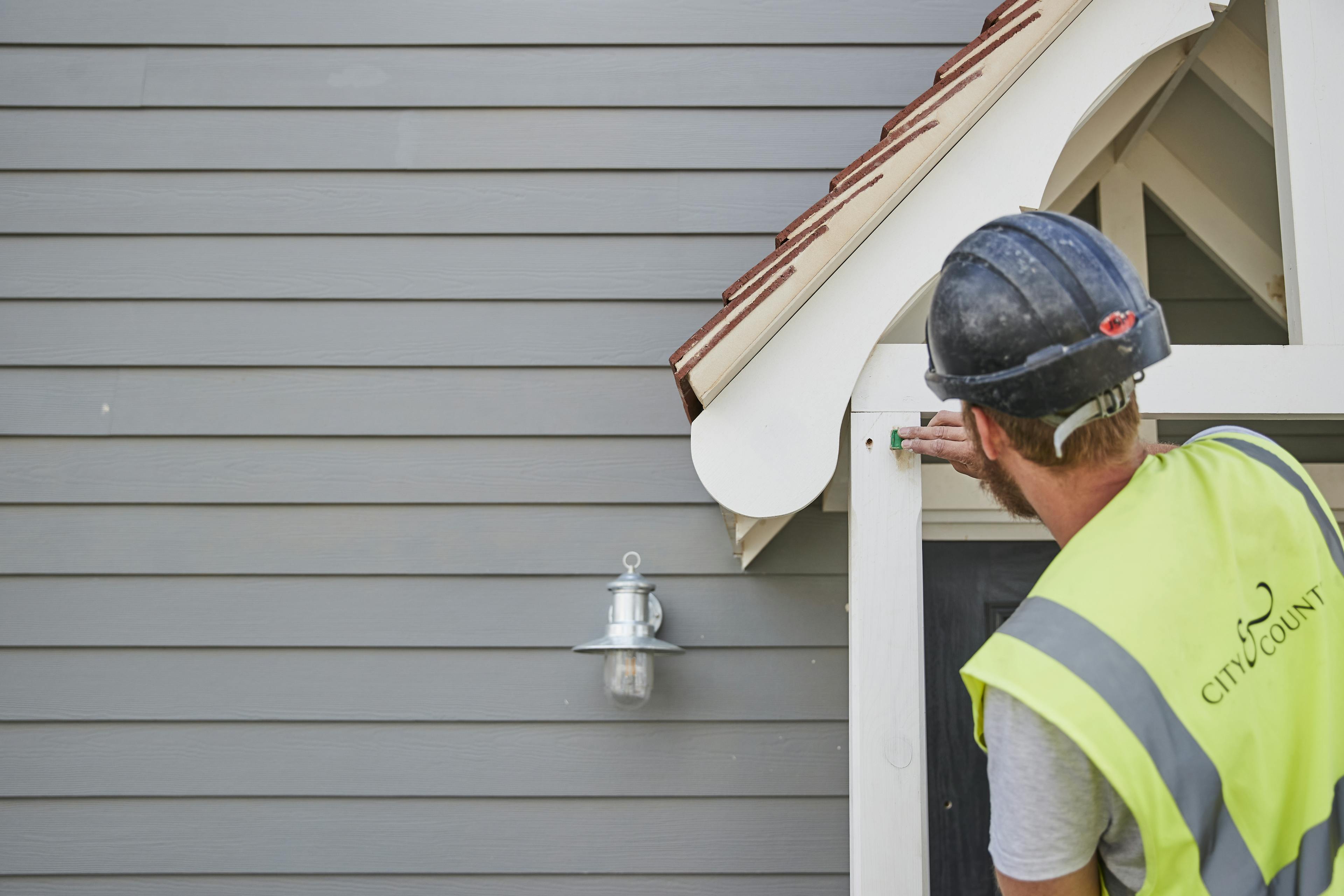 Caption: a man wearing a hard hat and safety vest