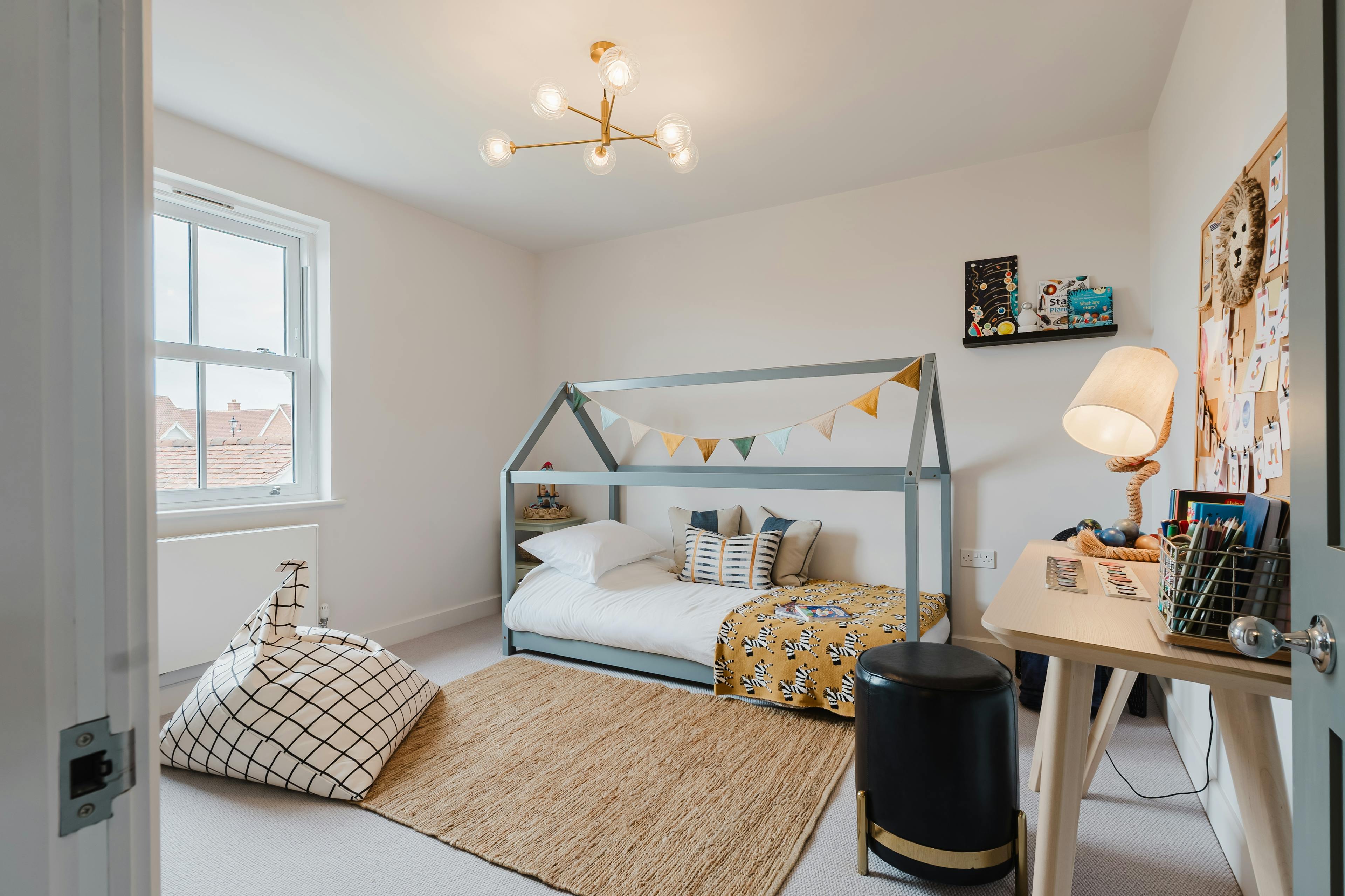 Caption: a child's bedroom with a bed and a desk