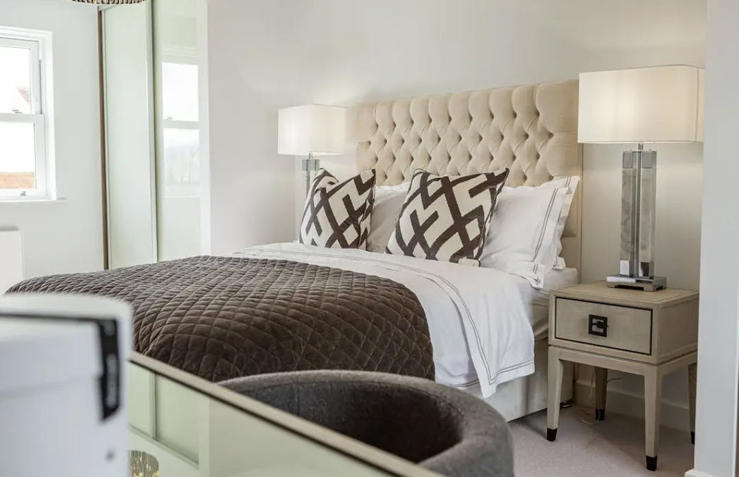 Caption: a bedroom with a bed and a mirror