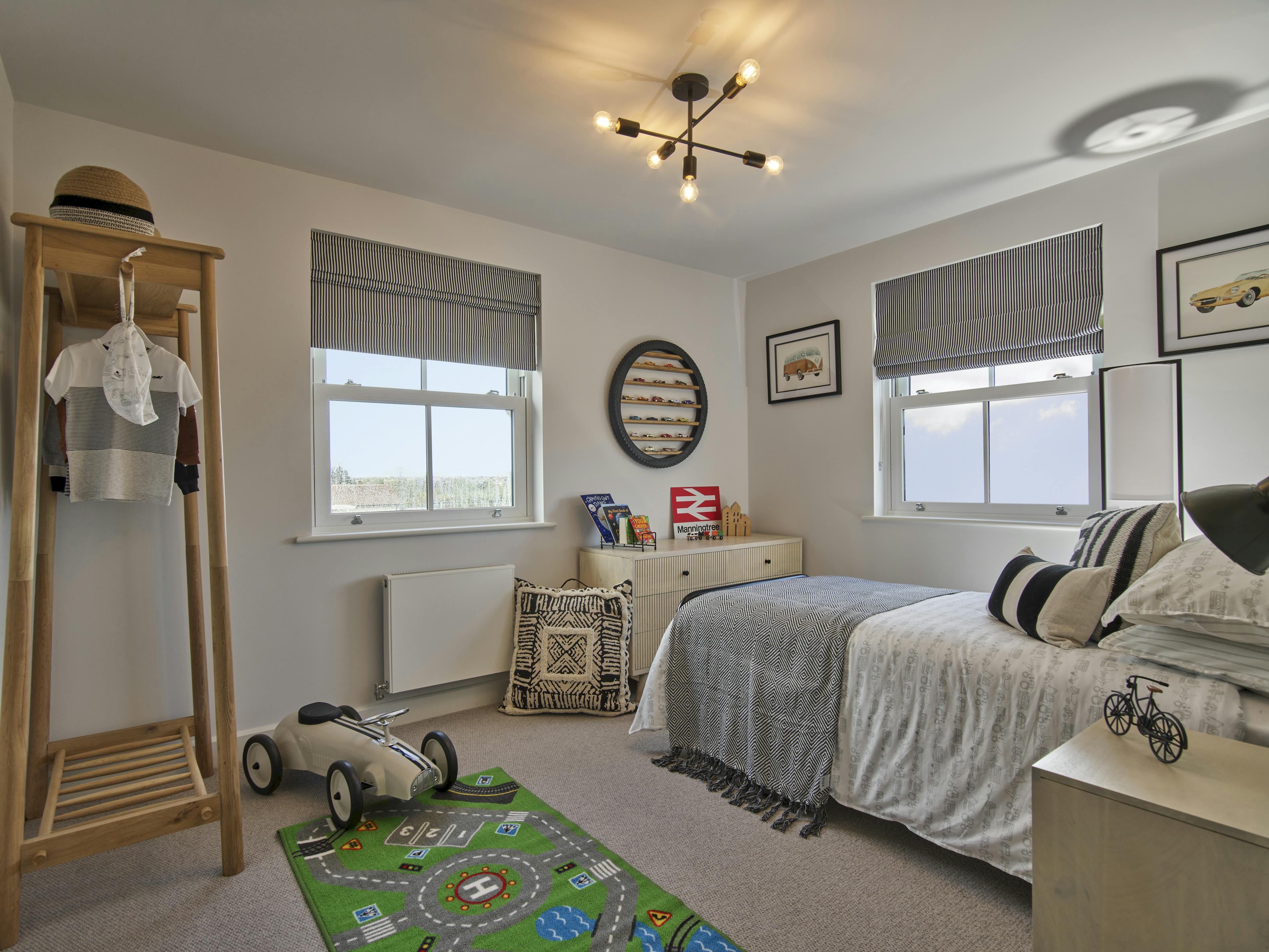 Caption: a child's bedroom with a toy car on the floor
