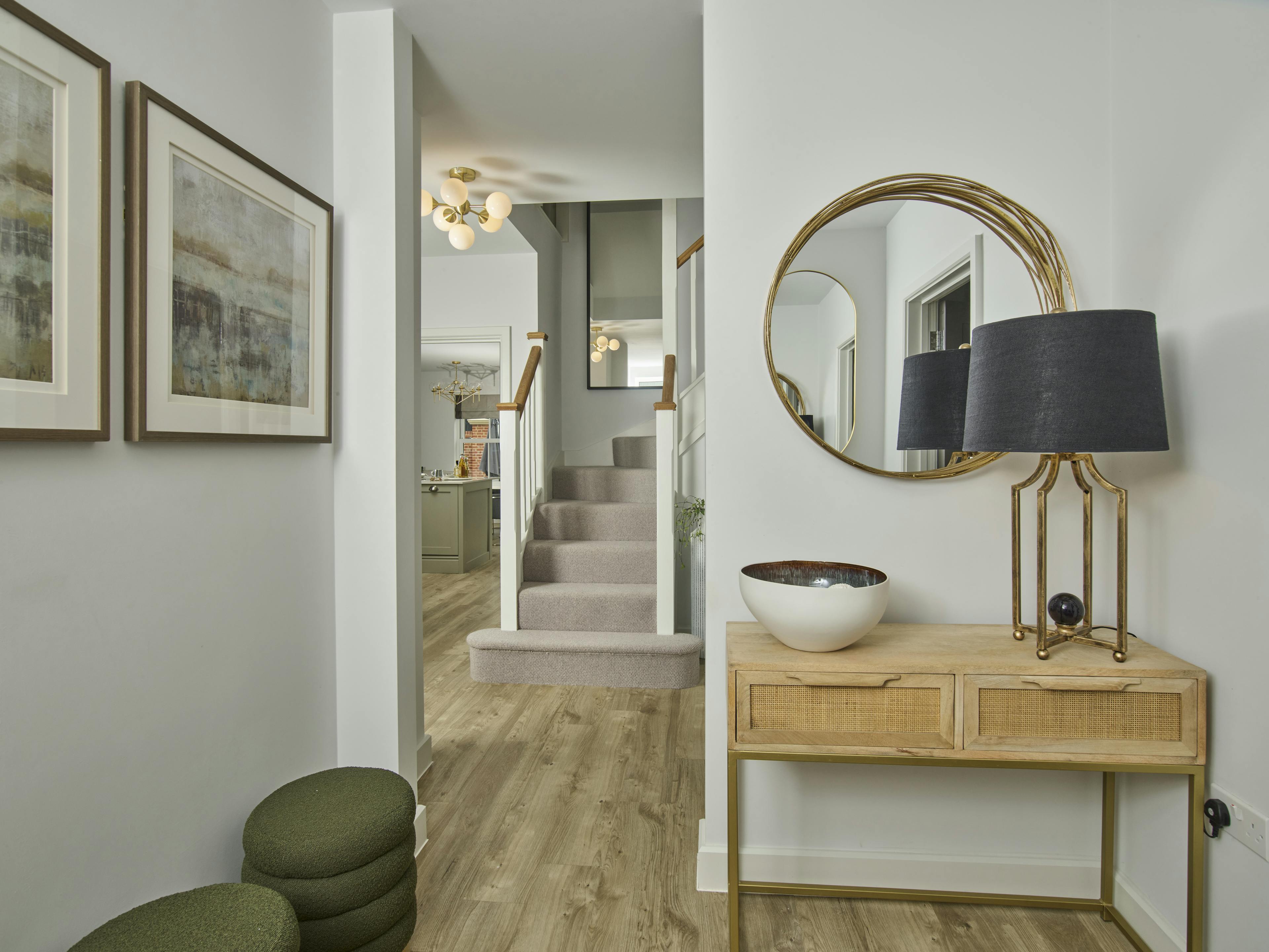 Caption: a hallway with a mirror and a table with a bowl on it