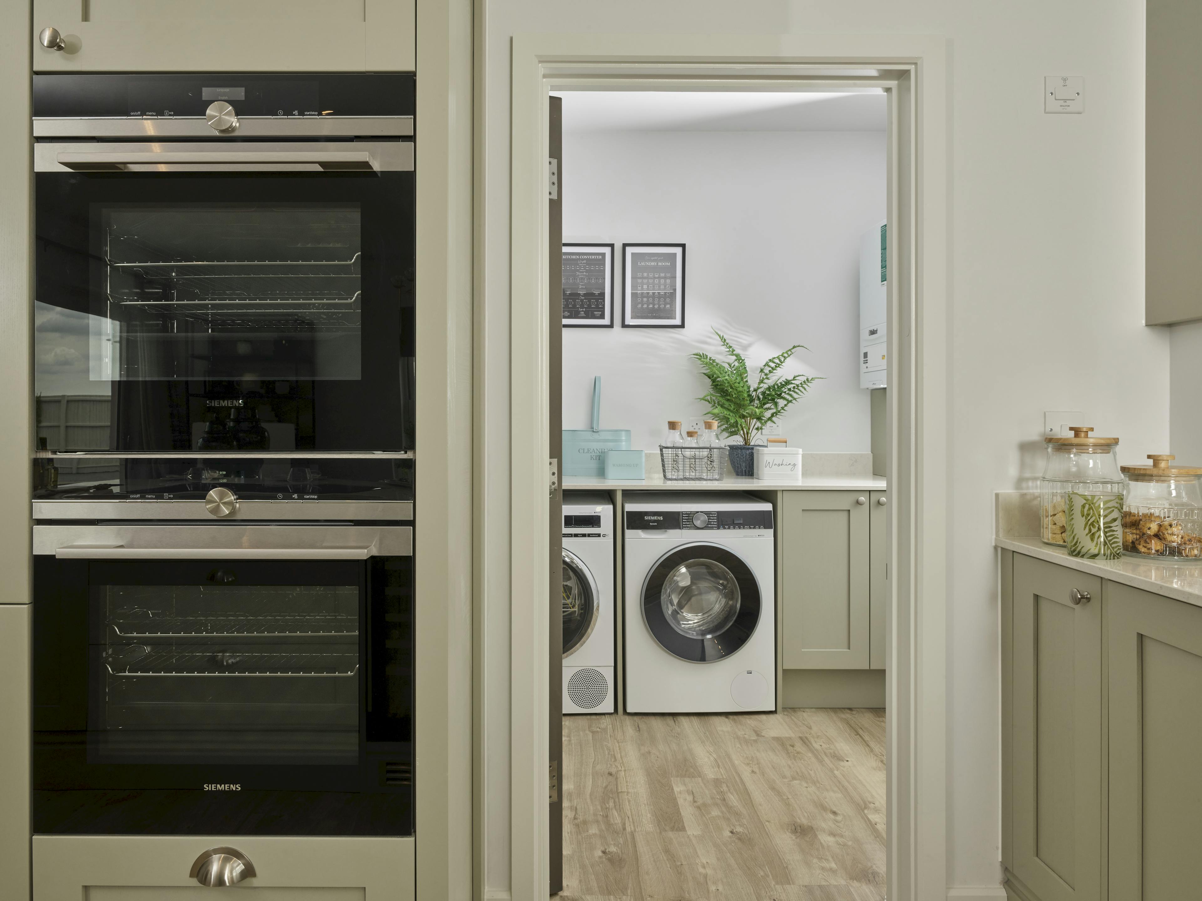 Caption: a kitchen with a washer and dryer in it