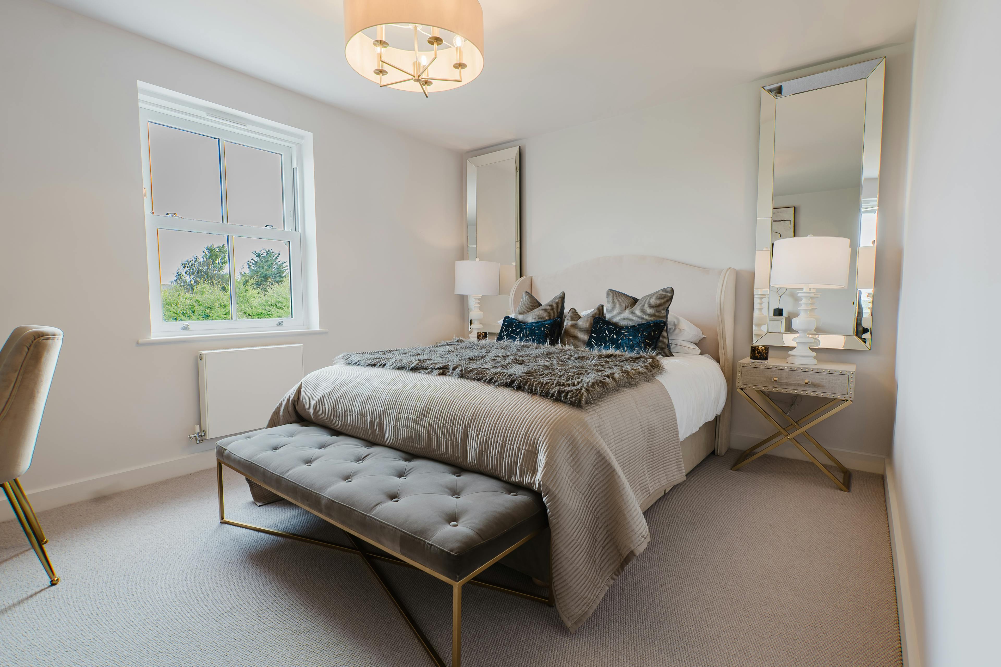 Caption: a bedroom with a large bed and a chair