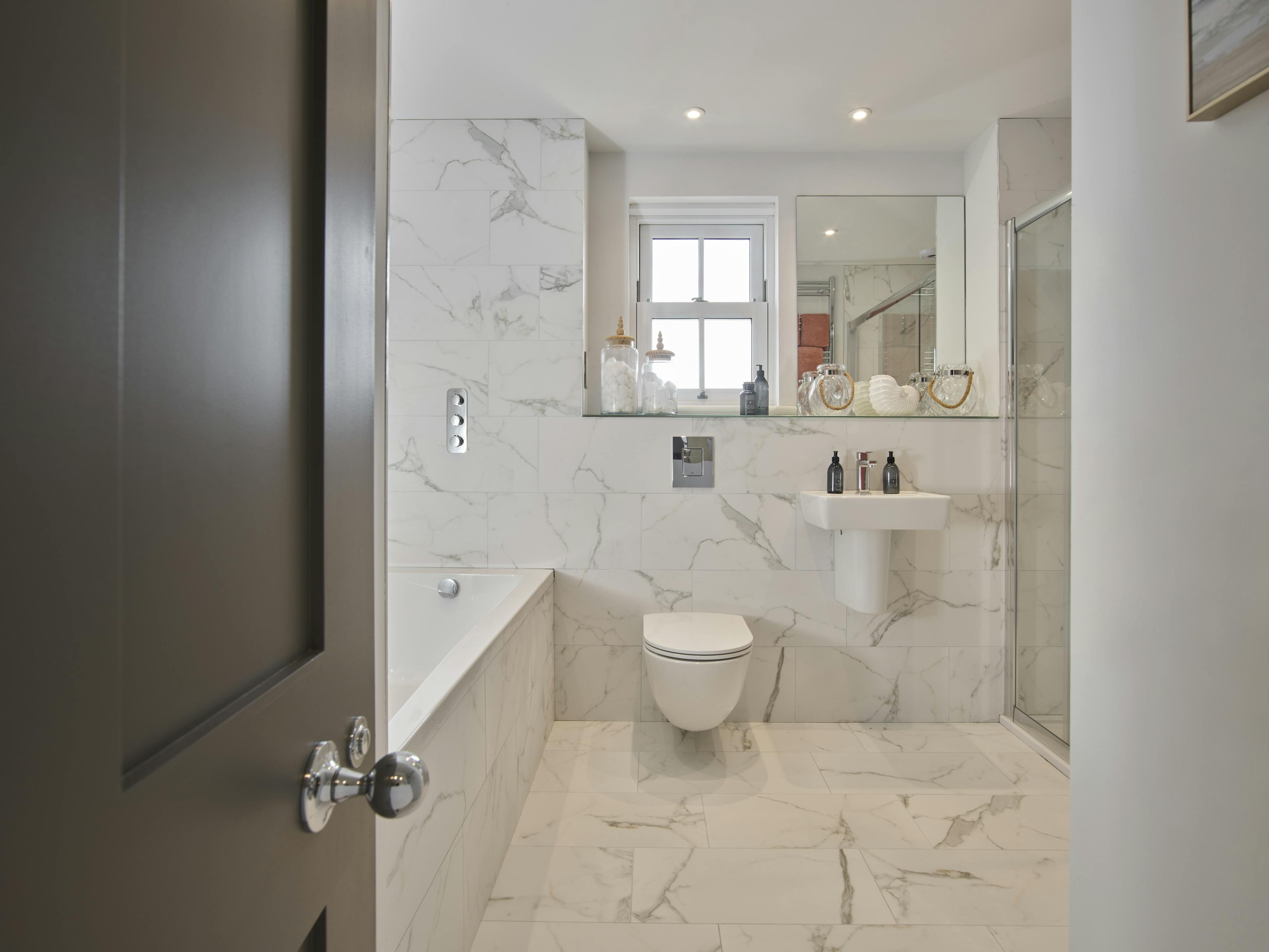 Caption: a bathroom with a toilet, sink, and shower