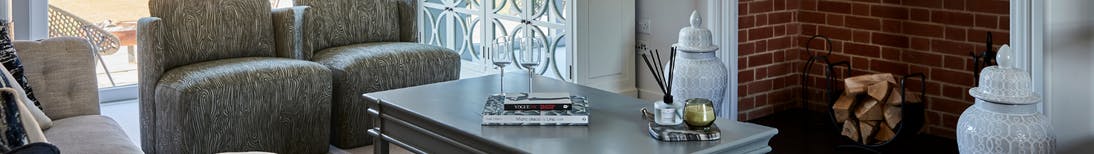 Caption: a living room filled with furniture and a fire place