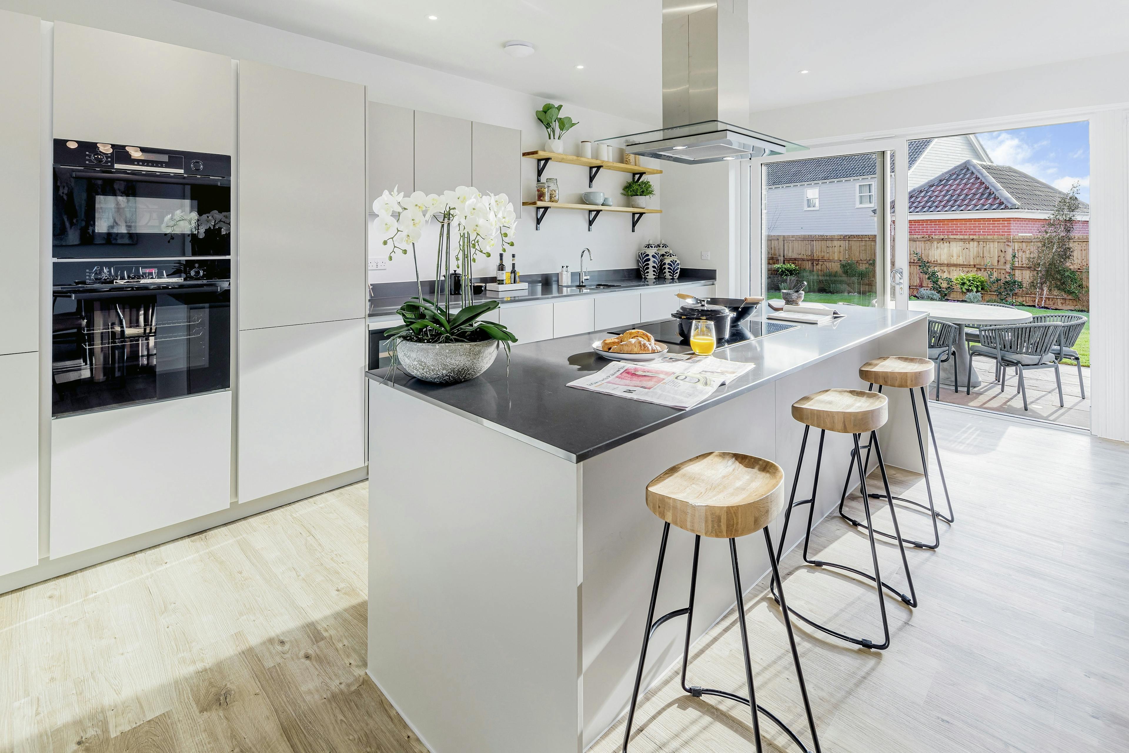 Caption: a kitchen with a center island with stools