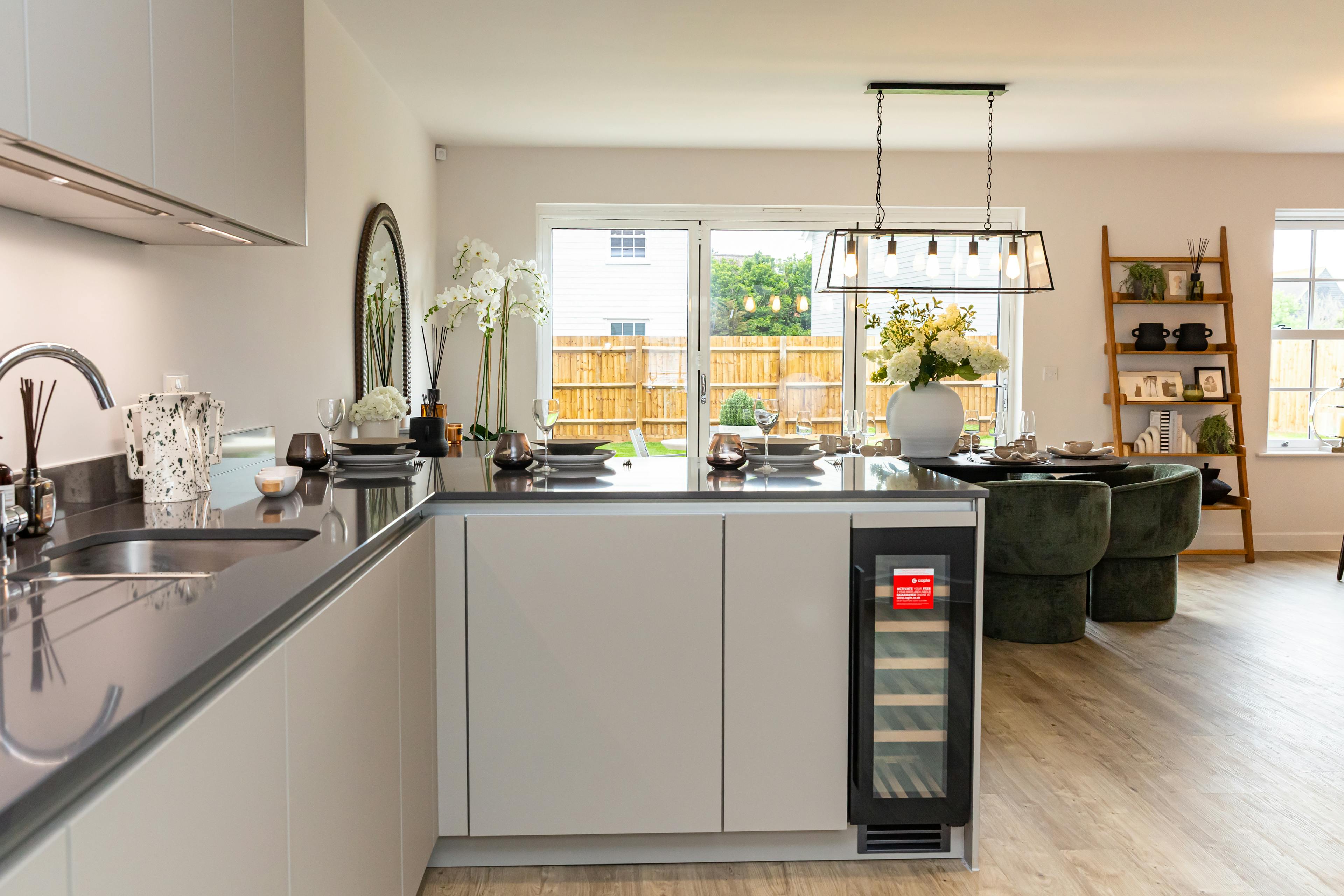 Caption: a kitchen with a wine cooler in the middle of it